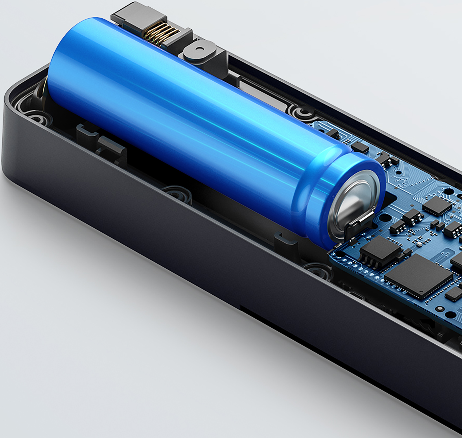 Internal view of a blue battery inside a black device, with circuit board visible.