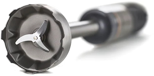 A close-up of a blender blade. The blade is silver and the base is dark.