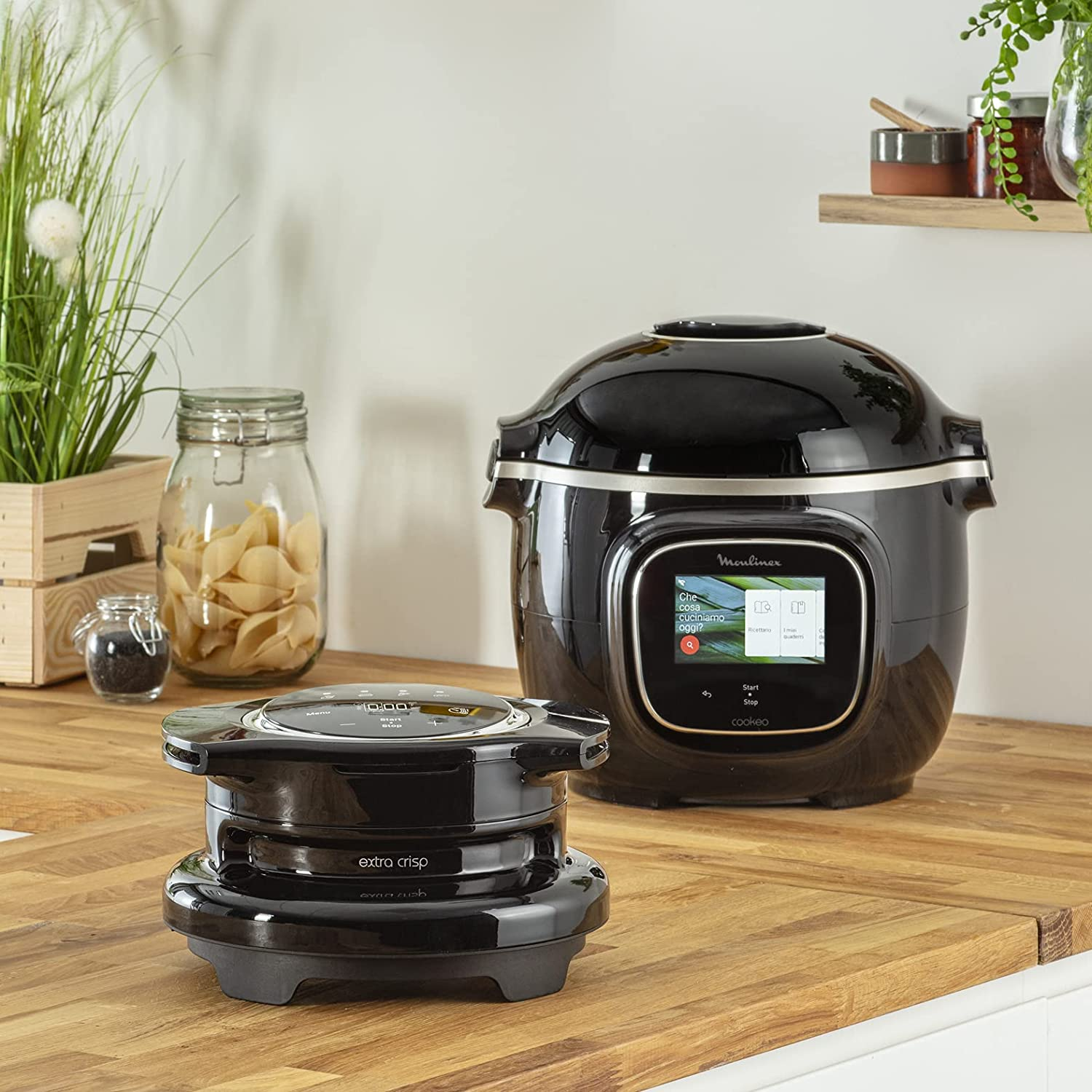 Black Moulinex Cookeo with extra crisp accessory on a wooden countertop.