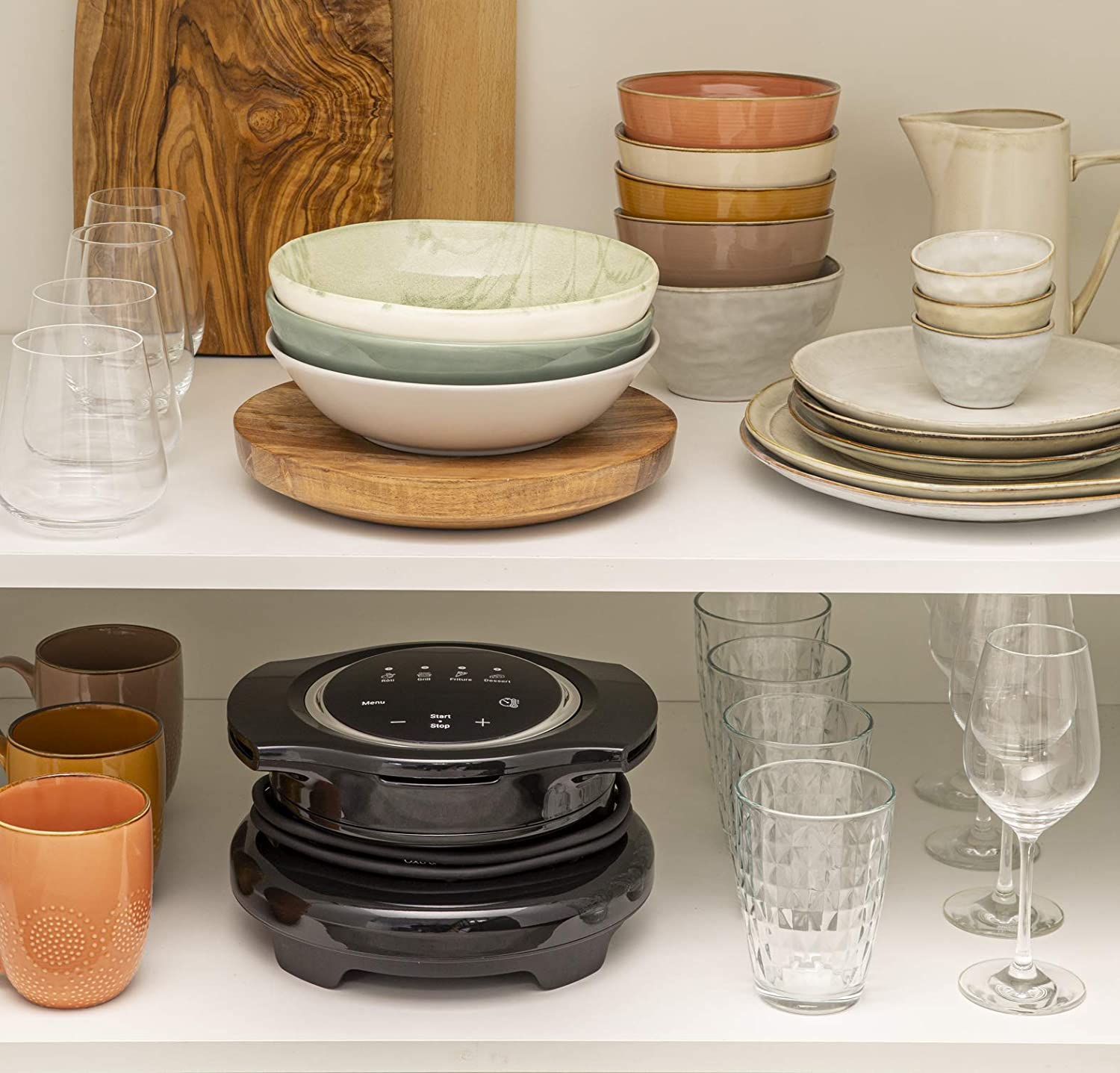 Shelves with various kitchenware, including bowls, plates, and glasses.