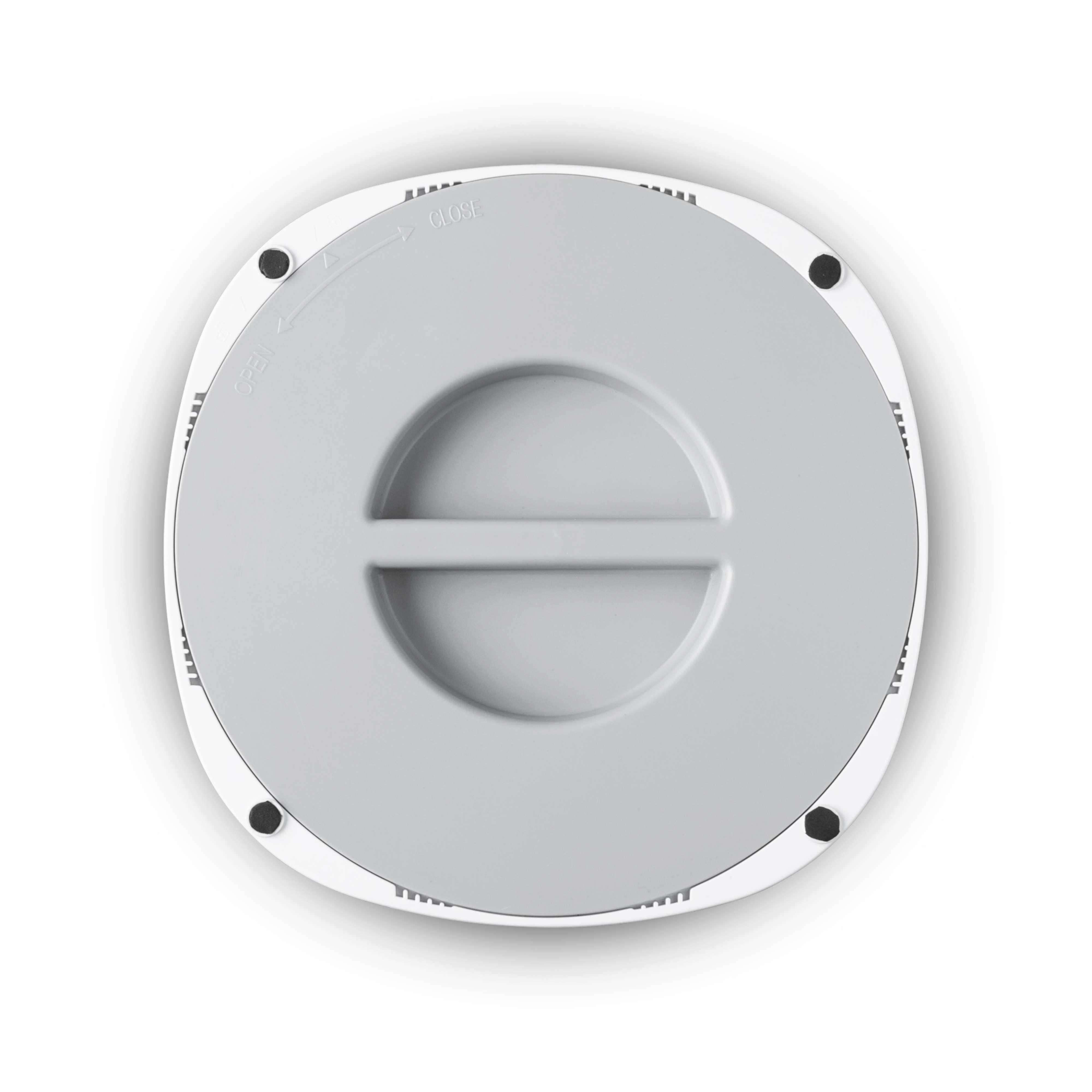 Ein weißer runder Deckel mit grauem Zentrum und schwarzen Punkten. Pfeil für öffnen/schließen.