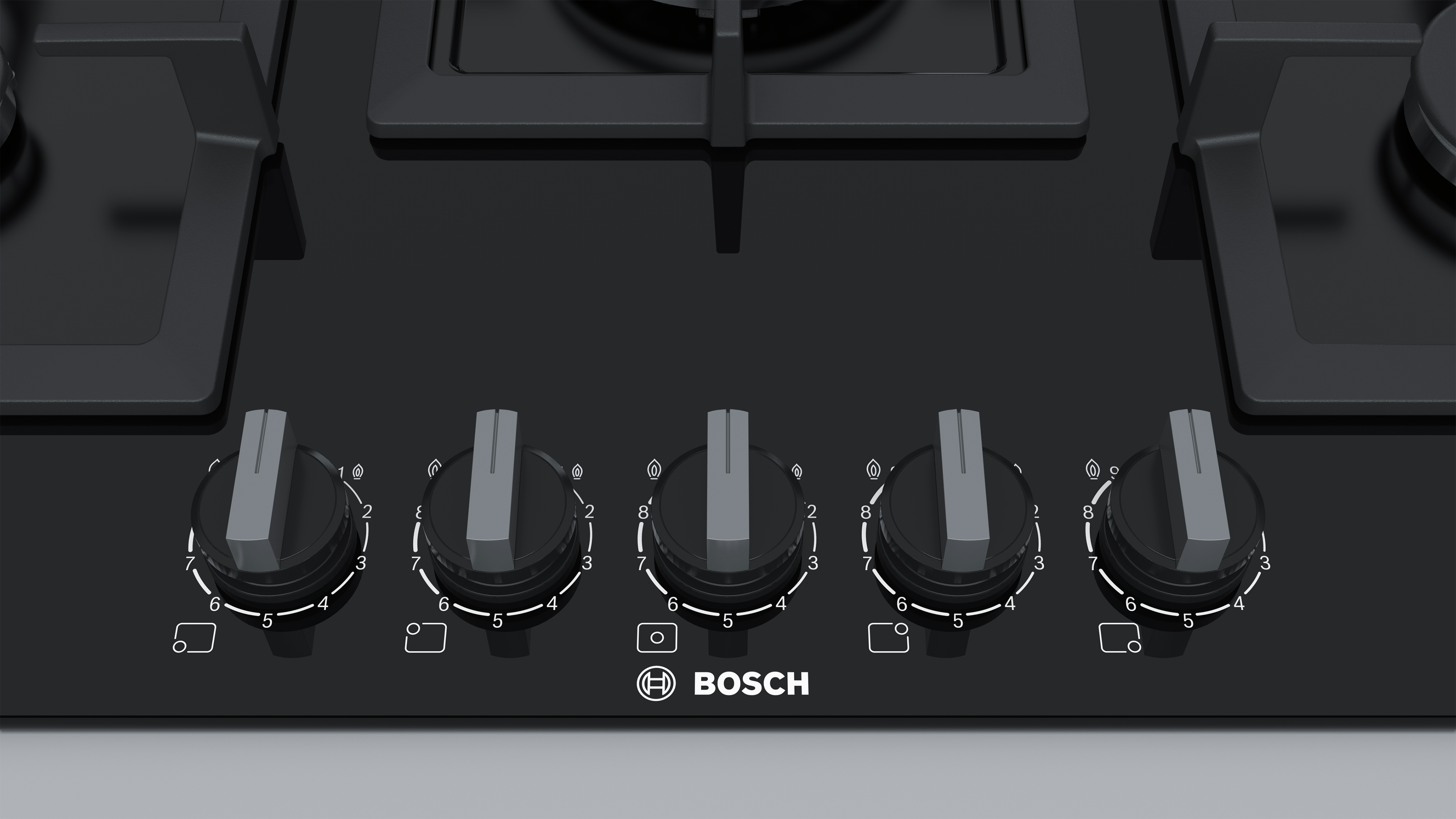 Close-up of a black gas stove control panel with five knobs and the Bosch logo.