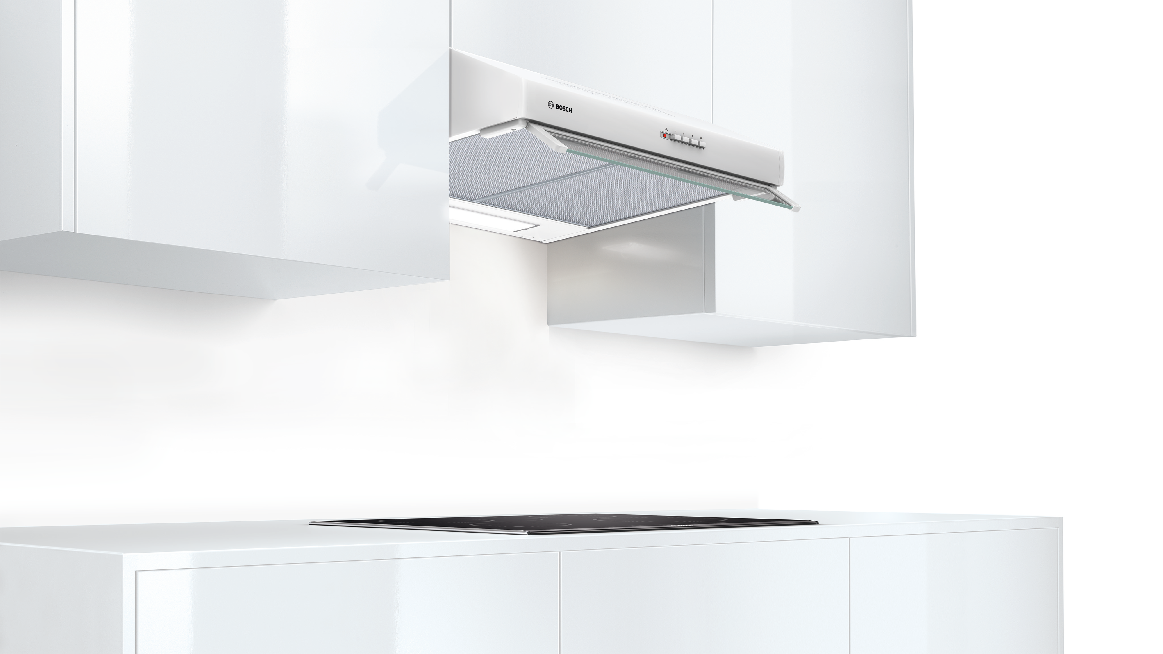 A white Bosch range hood installed above a stovetop, with white cabinets in the background.