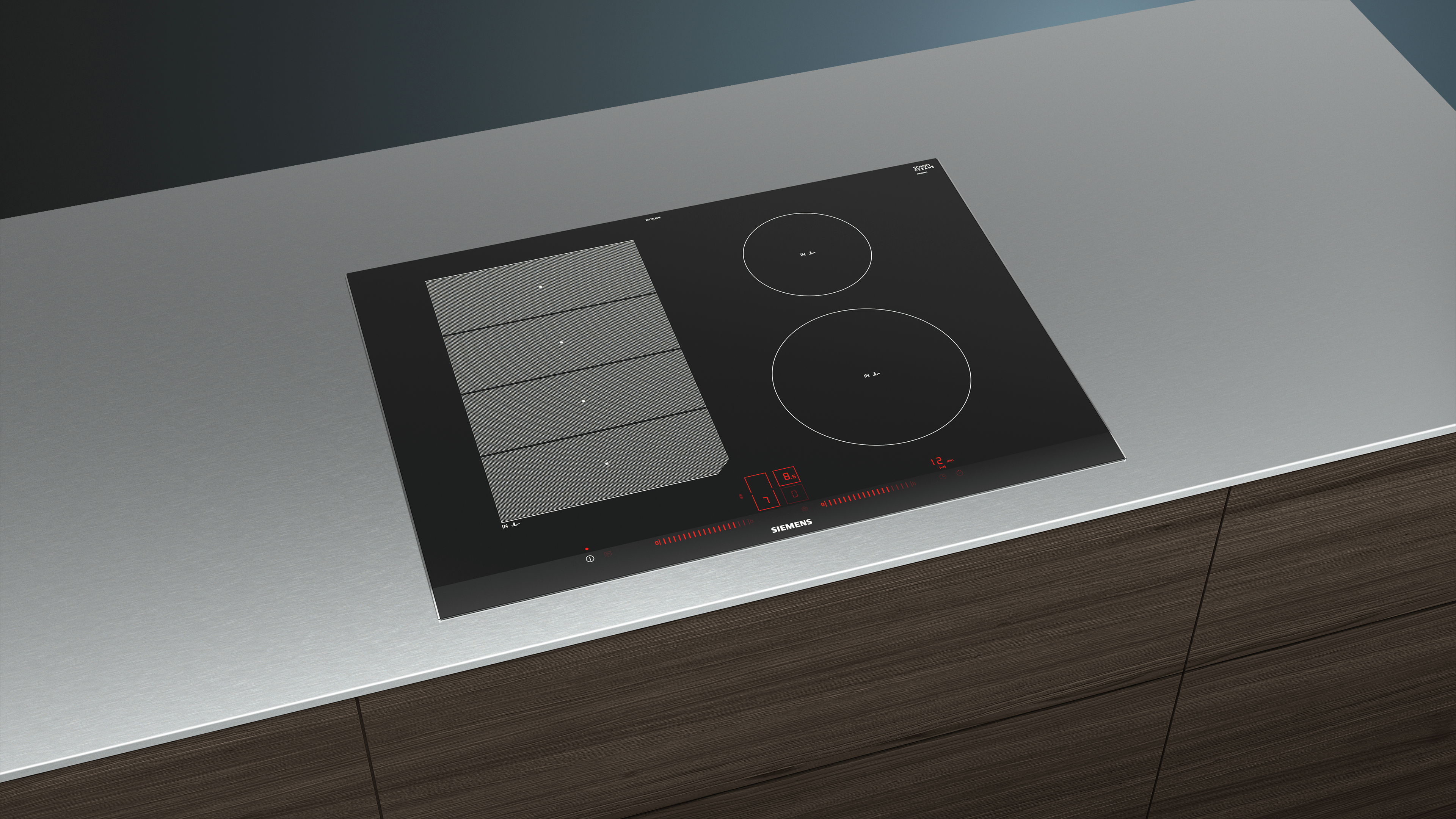 Table de cuisson à induction noire sur plan de travail gris avec deux zones.