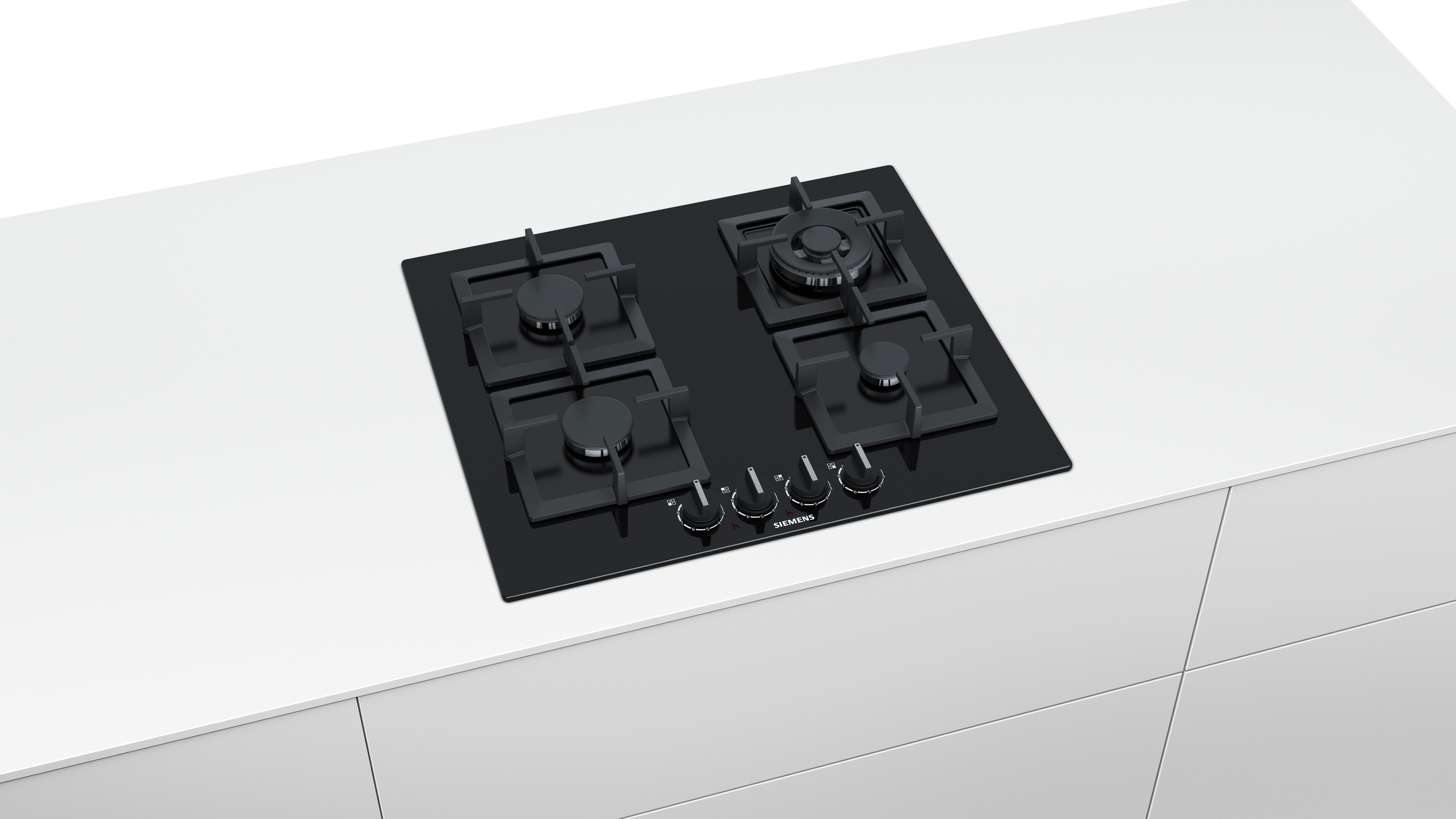 A stainless steel range hood above a black cooktop, against a white wall.