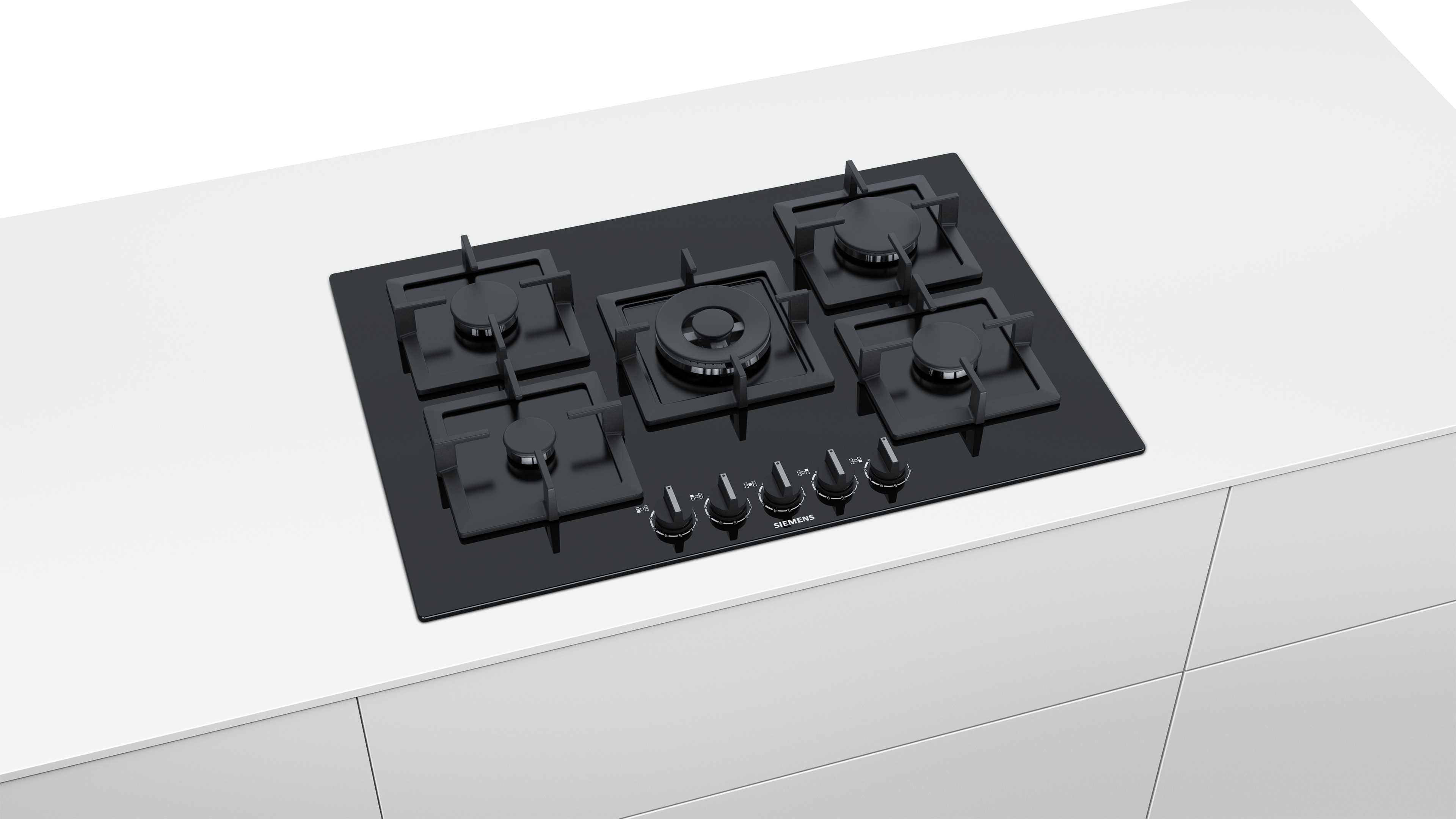 Black stovetop with five burners on a white surface.
