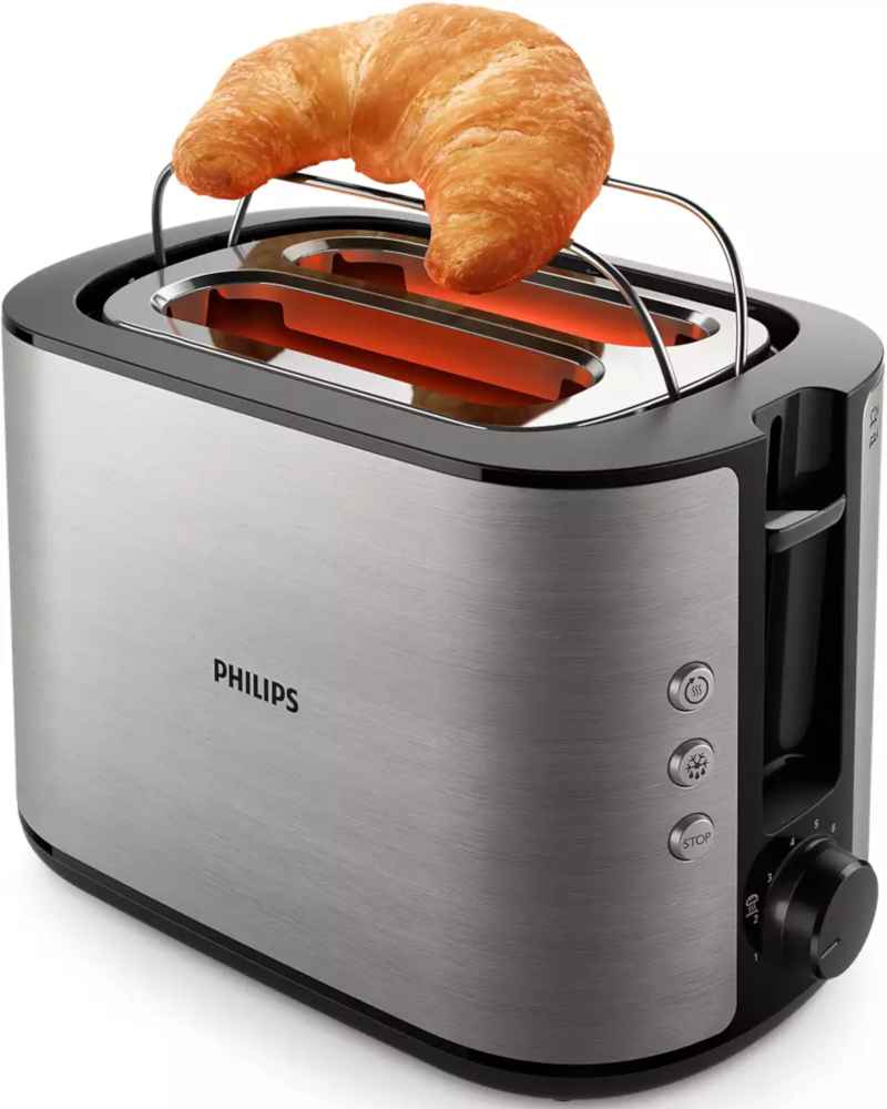 Silver toaster with a croissant on top. The heating elements glow. The right side has buttons and a dial.