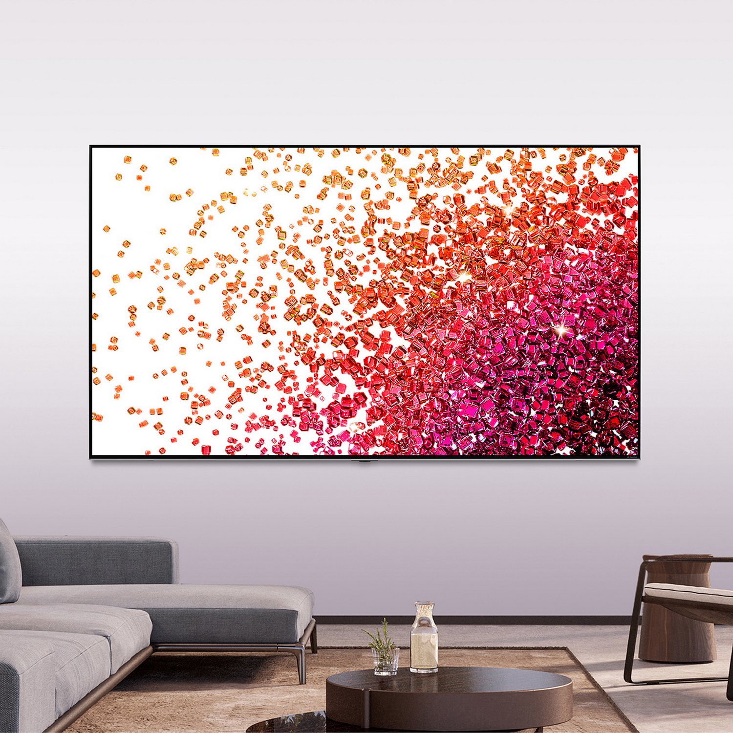 Una pantalla de TV grande muestra un patrón abstracto rojo y rosa de cubos.