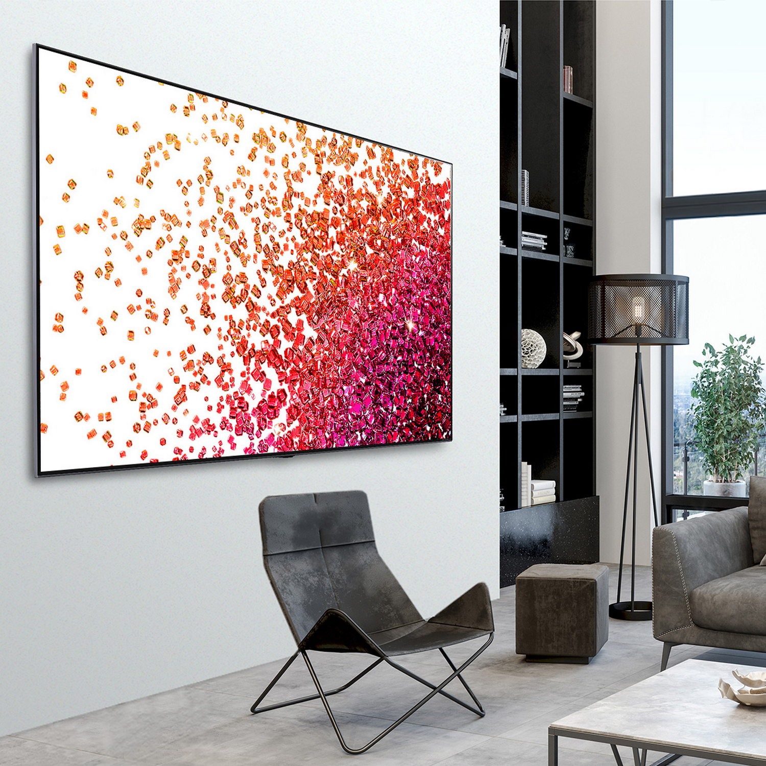 Un televisor grande montado en una pared blanca, con marco negro. Arte abstracto.