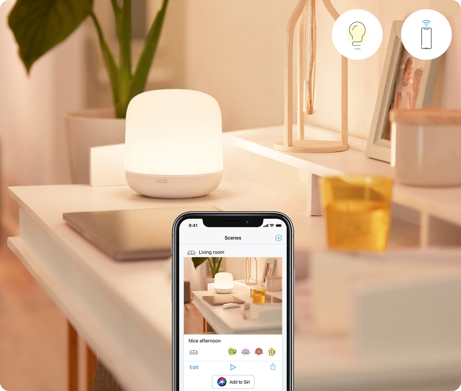A lamp and phone on a white surface. The phone displays a smart home app interface.