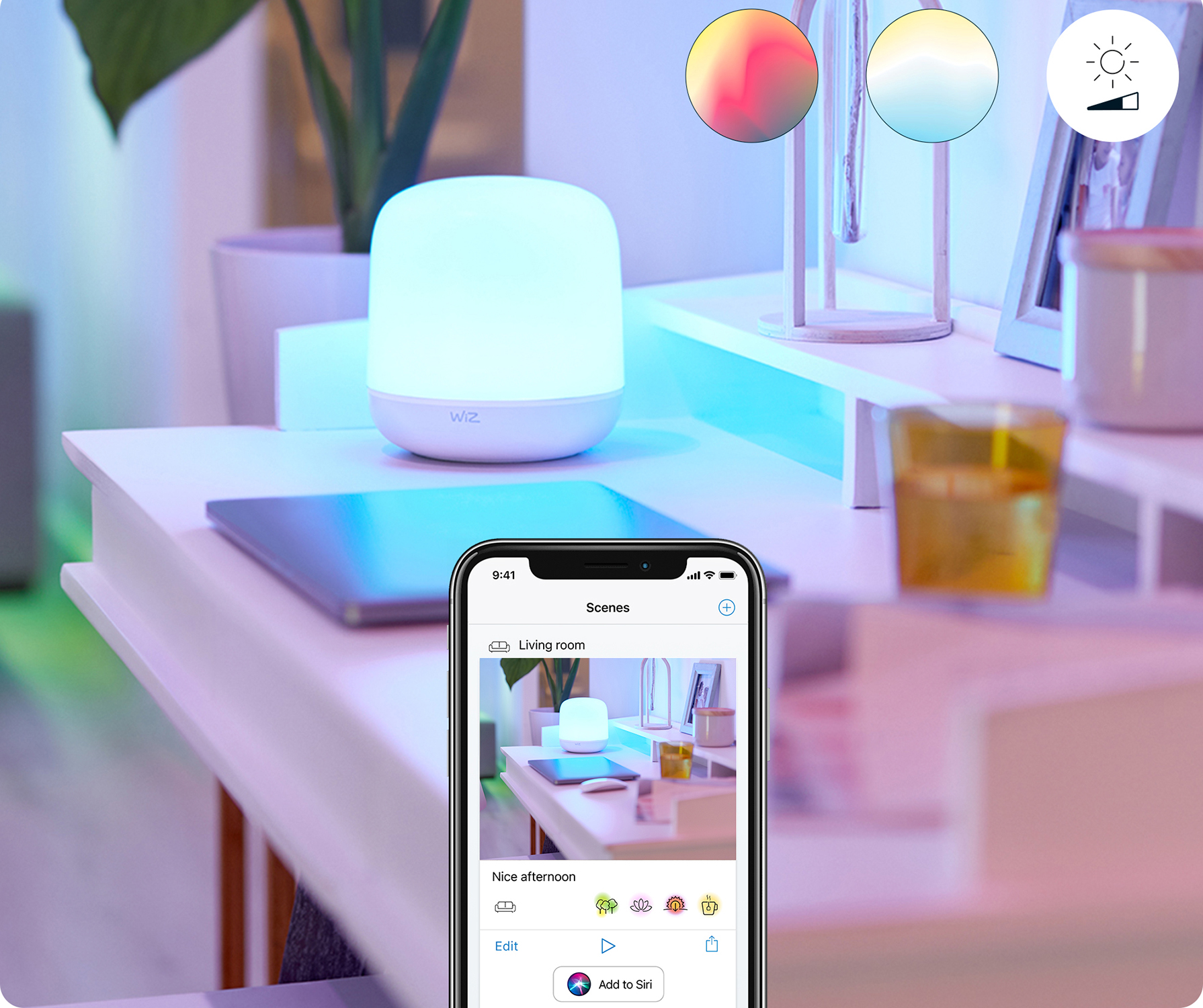A smartphone displaying a smart home app next to a white lamp with color changing options.