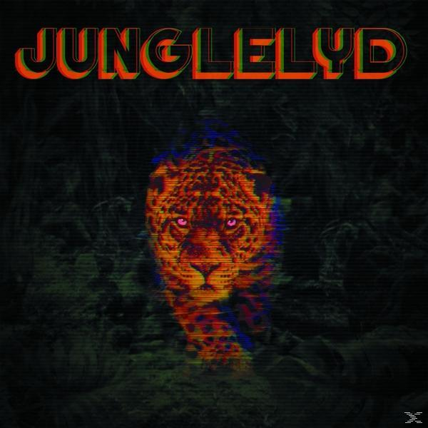 Jaguar-Gesicht mit Text 'JUNGLELYD' darüber. Dunkler, verschwommener Hintergrund mit Laub.