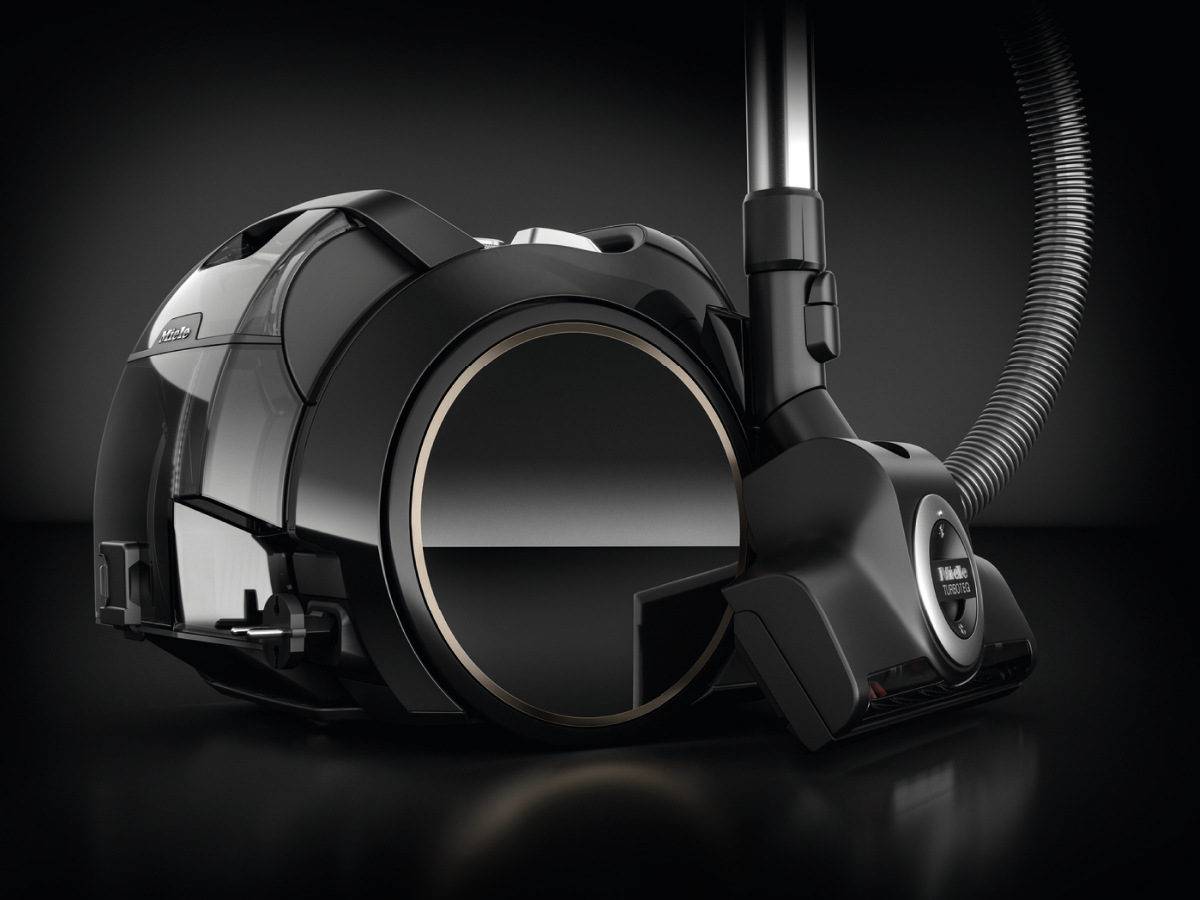 Black vacuum cleaner with a transparent dust container and a round feature.