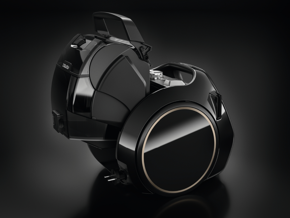 Black vacuum cleaner with gold accents and a unique design.