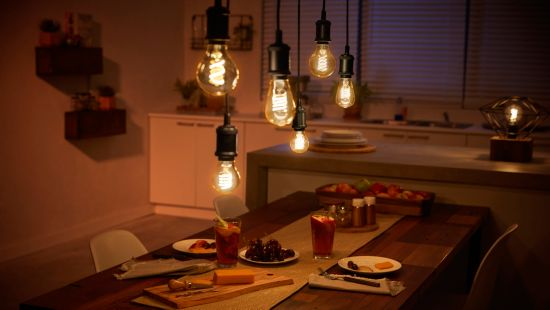 Salle à manger avec des suspensions au-dessus d'une table avec de la nourriture et des boissons.