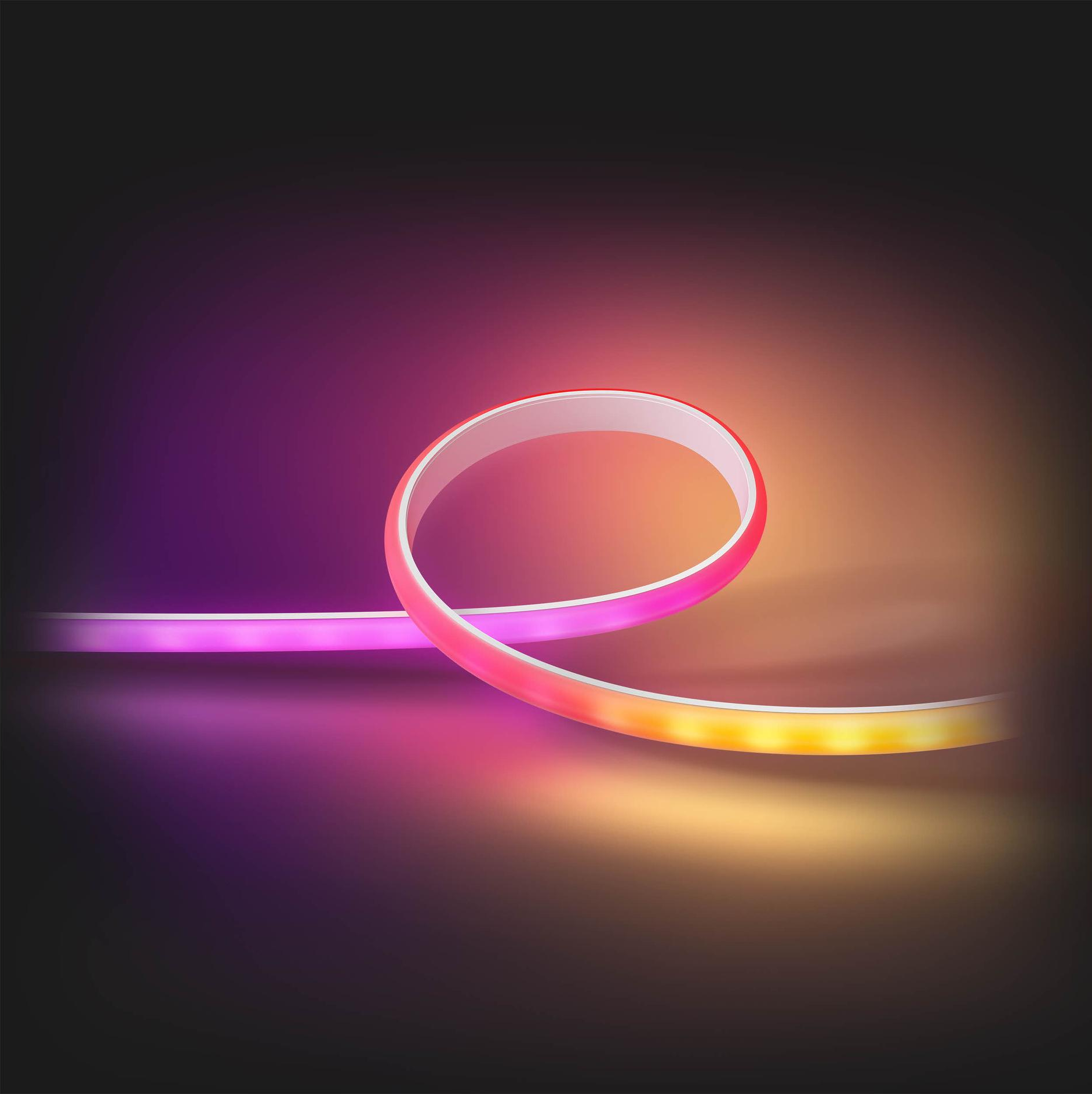 Una striscia luminosa a LED flessibile, curva. I colori passano dal viola al rosa al giallo.