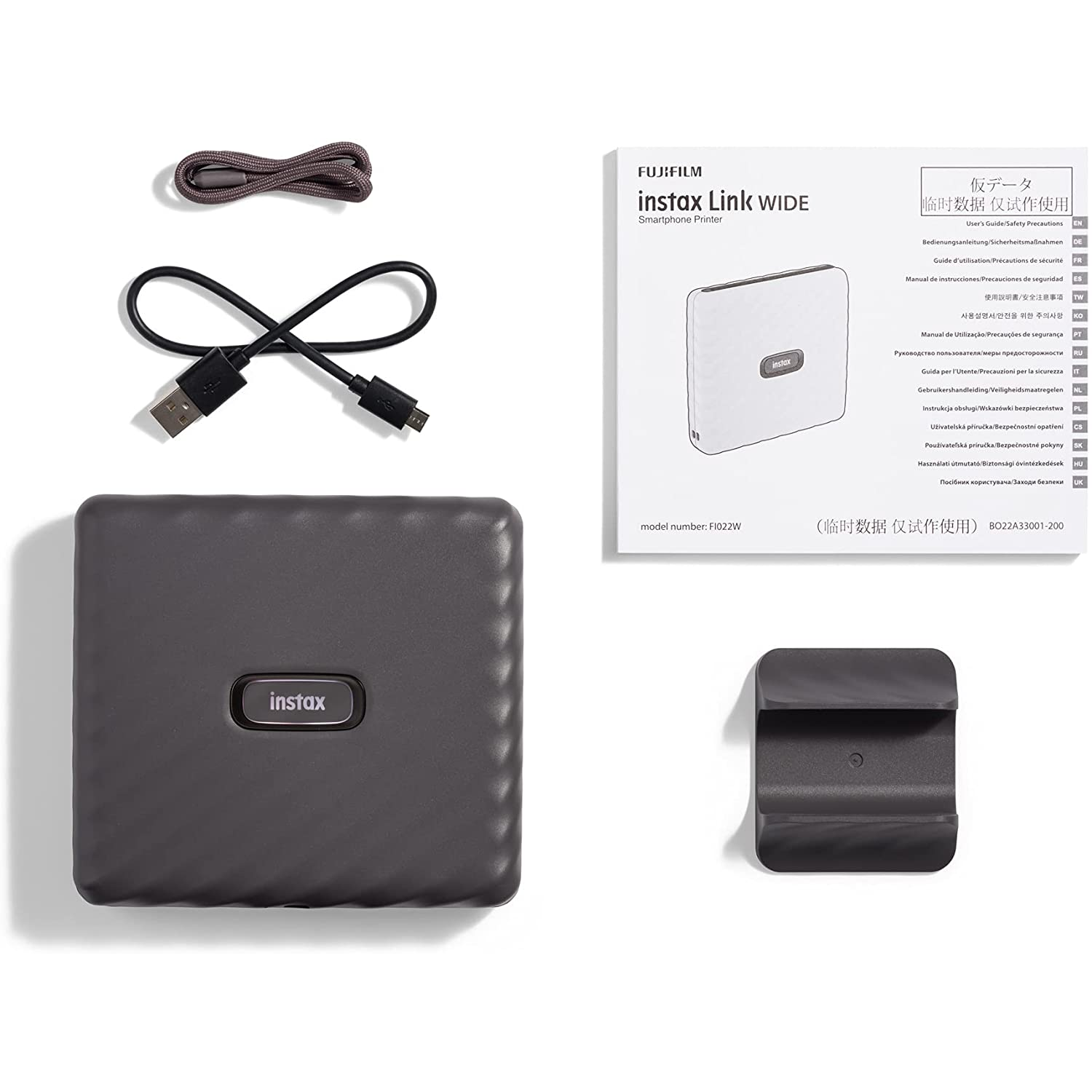 Impresora Instax Link Wide, accesorios y manual sobre blanco.