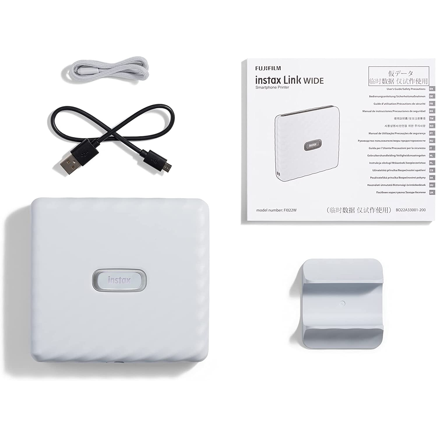 Impresora Fujifilm Instax Link Wide y accesorios sobre fondo blanco.