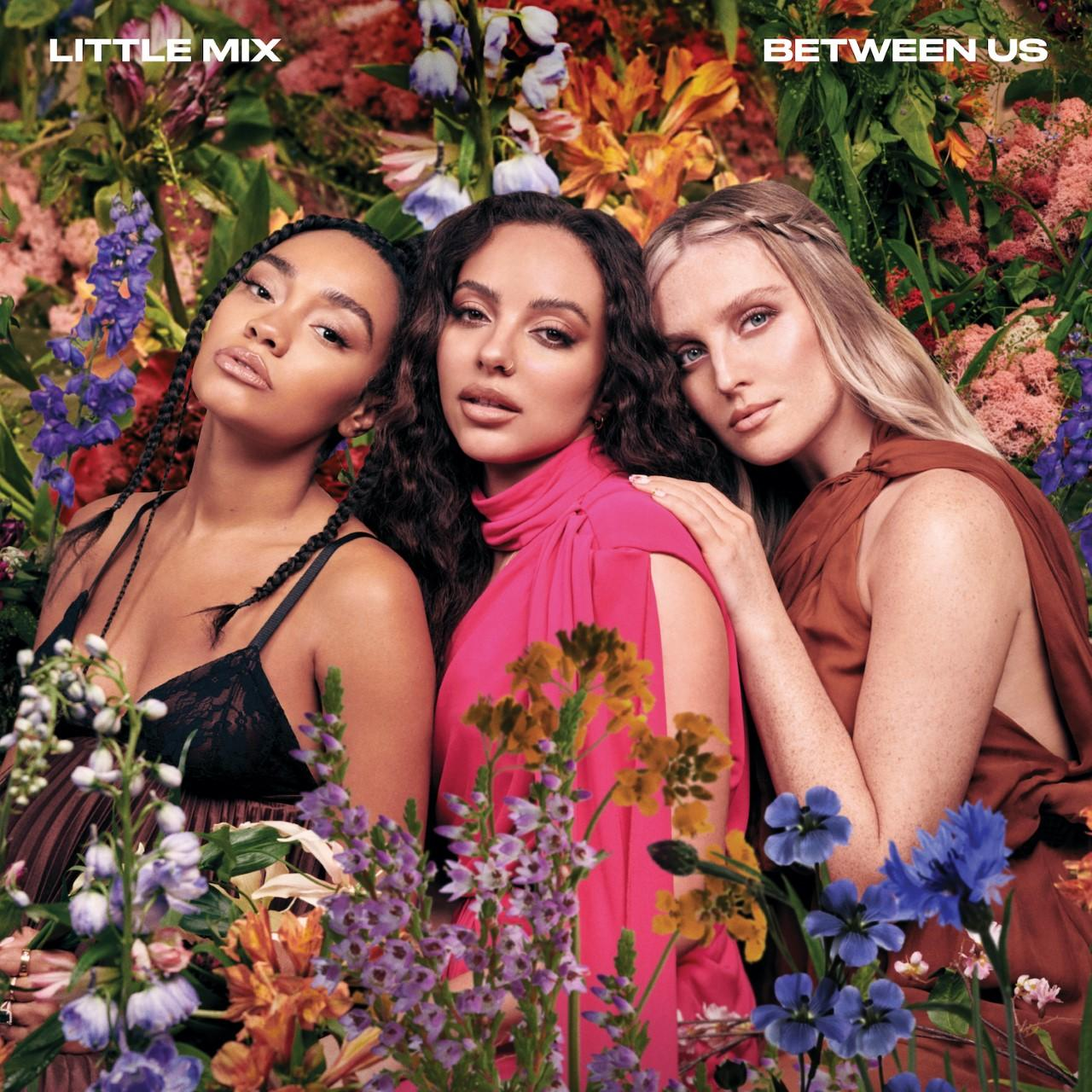 Pochette d'album de Little Mix, trois femmes devant des fleurs.