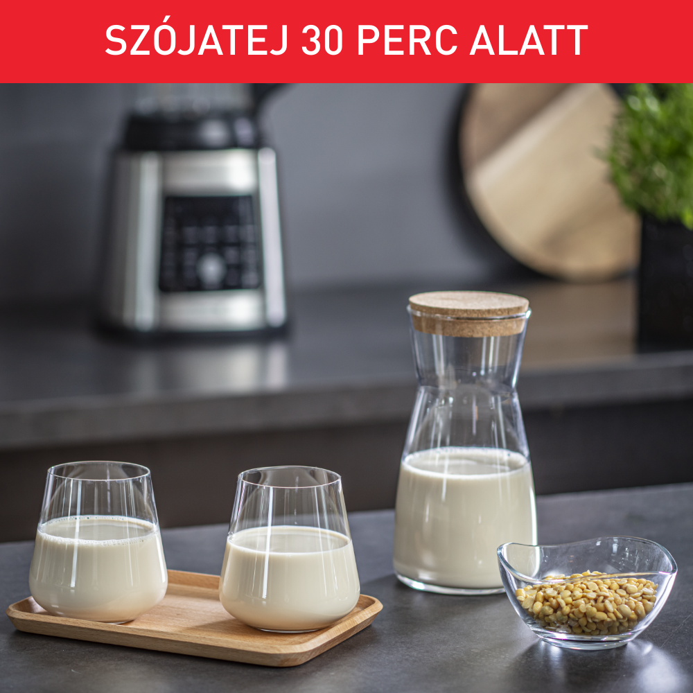 Szójatejes üvegek és egy kancsó egy fa tálcán, babos tálkával és turmixgéppel.