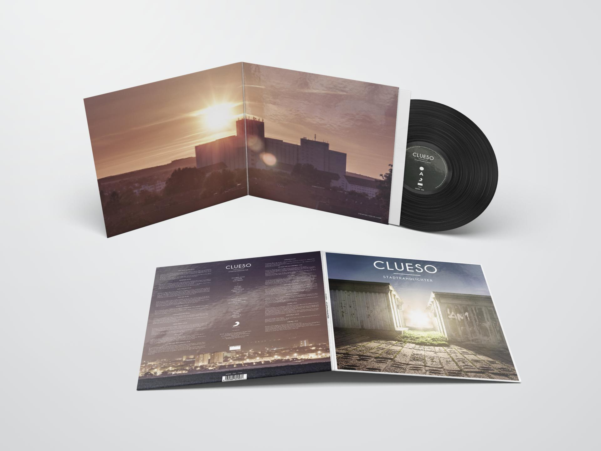 Vinylplatte mit Cover, das einen Sonnenuntergang und Gebäude zeigt, mit Text auf dem Cover.