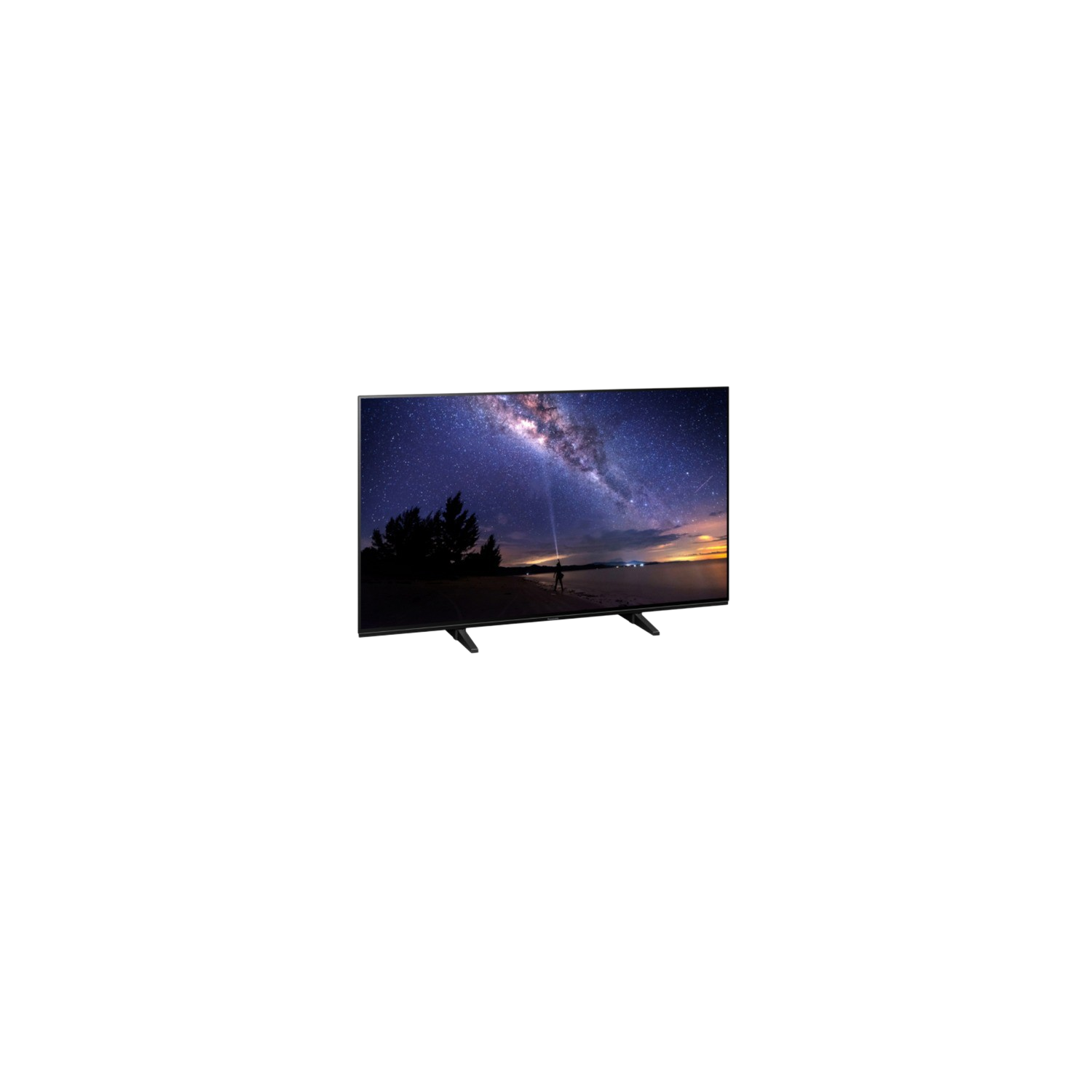 Una gran pantalla de TV muestra un cielo nocturno estrellado. Una persona en la playa.