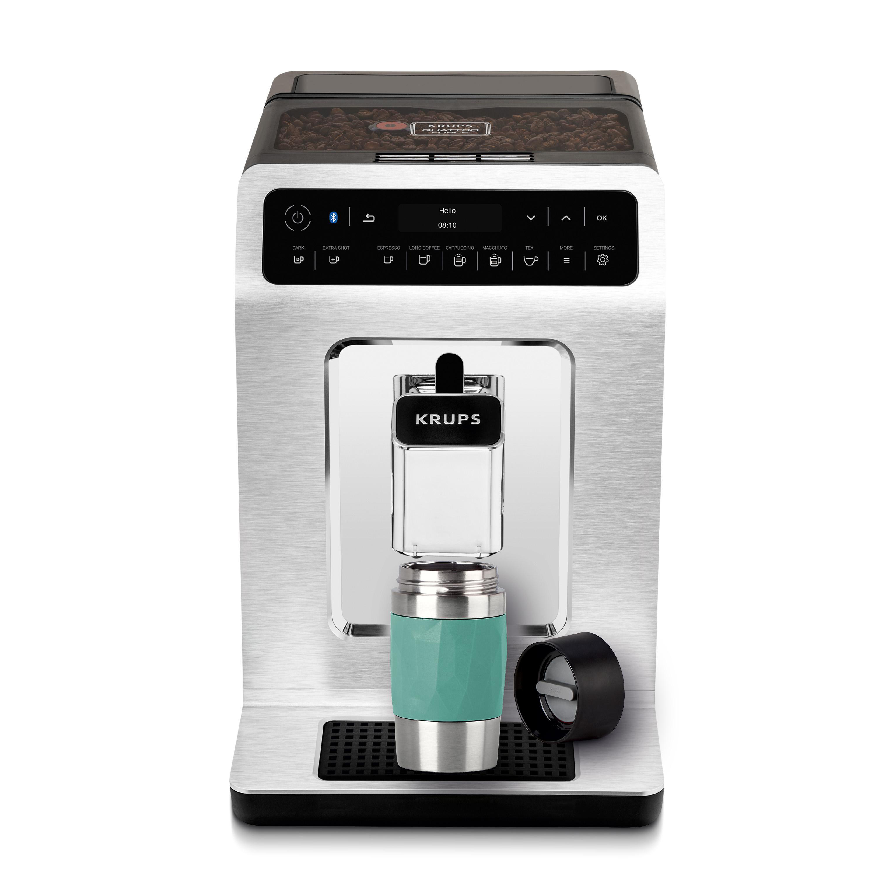 Eine silberne und schwarze KRUPS Kaffeemaschine mit Tasse und sichtbaren Bohnen. Weißer Hintergrund.