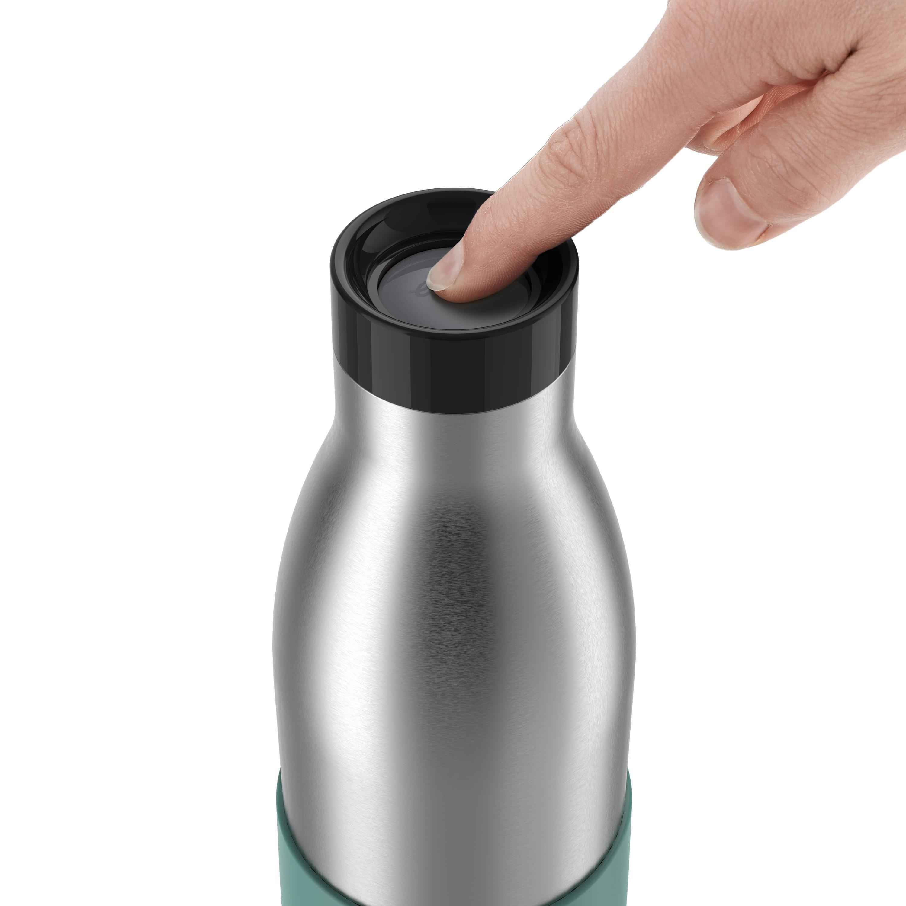 Eine Hand drückt auf die Oberseite einer Edelstahl-Wasserflasche mit einem türkisfarbenen Band.