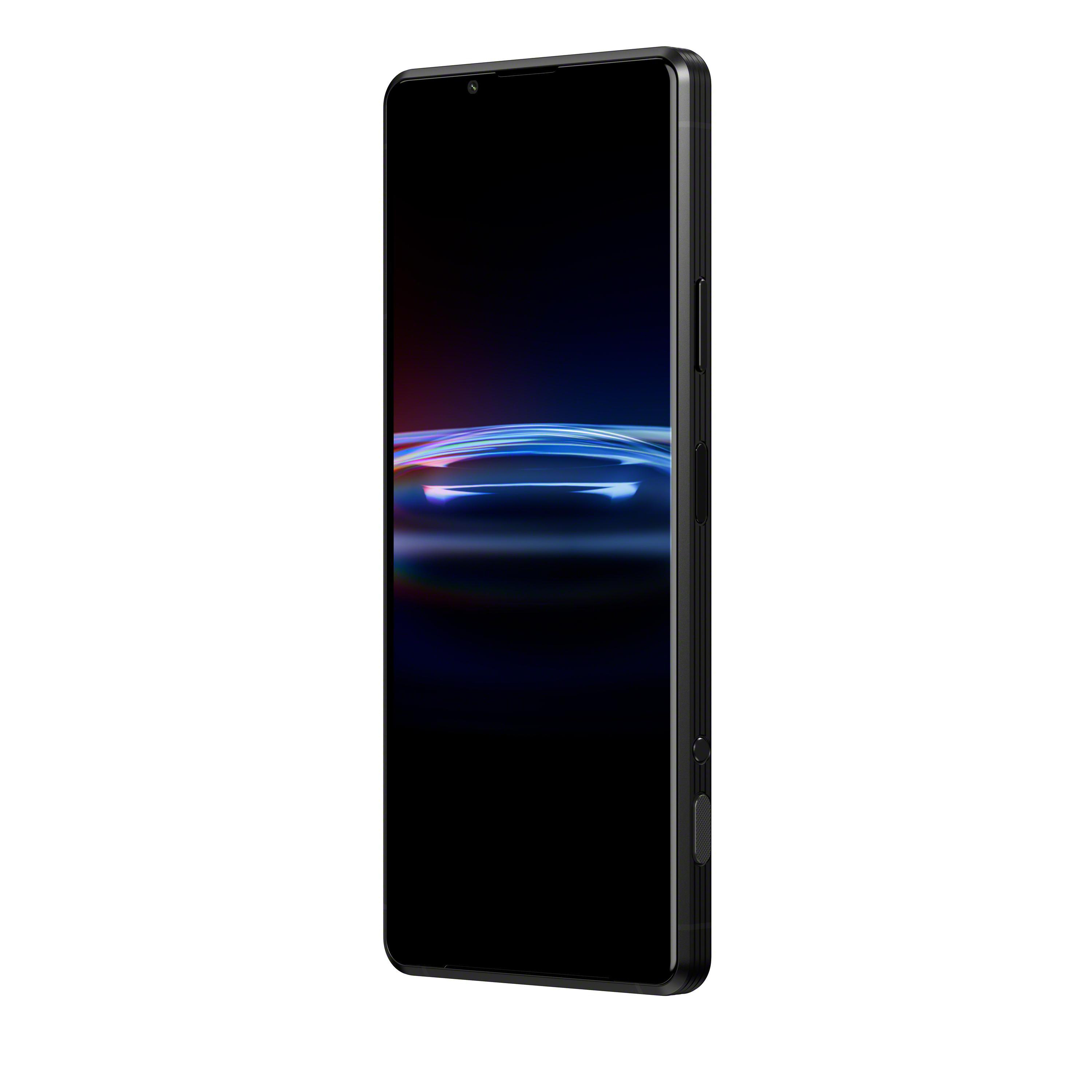 Schwarzes Smartphone, Seitenansicht. Der Bildschirm ist ausgeschaltet, mit einem blauen Farbton am unteren Rand.