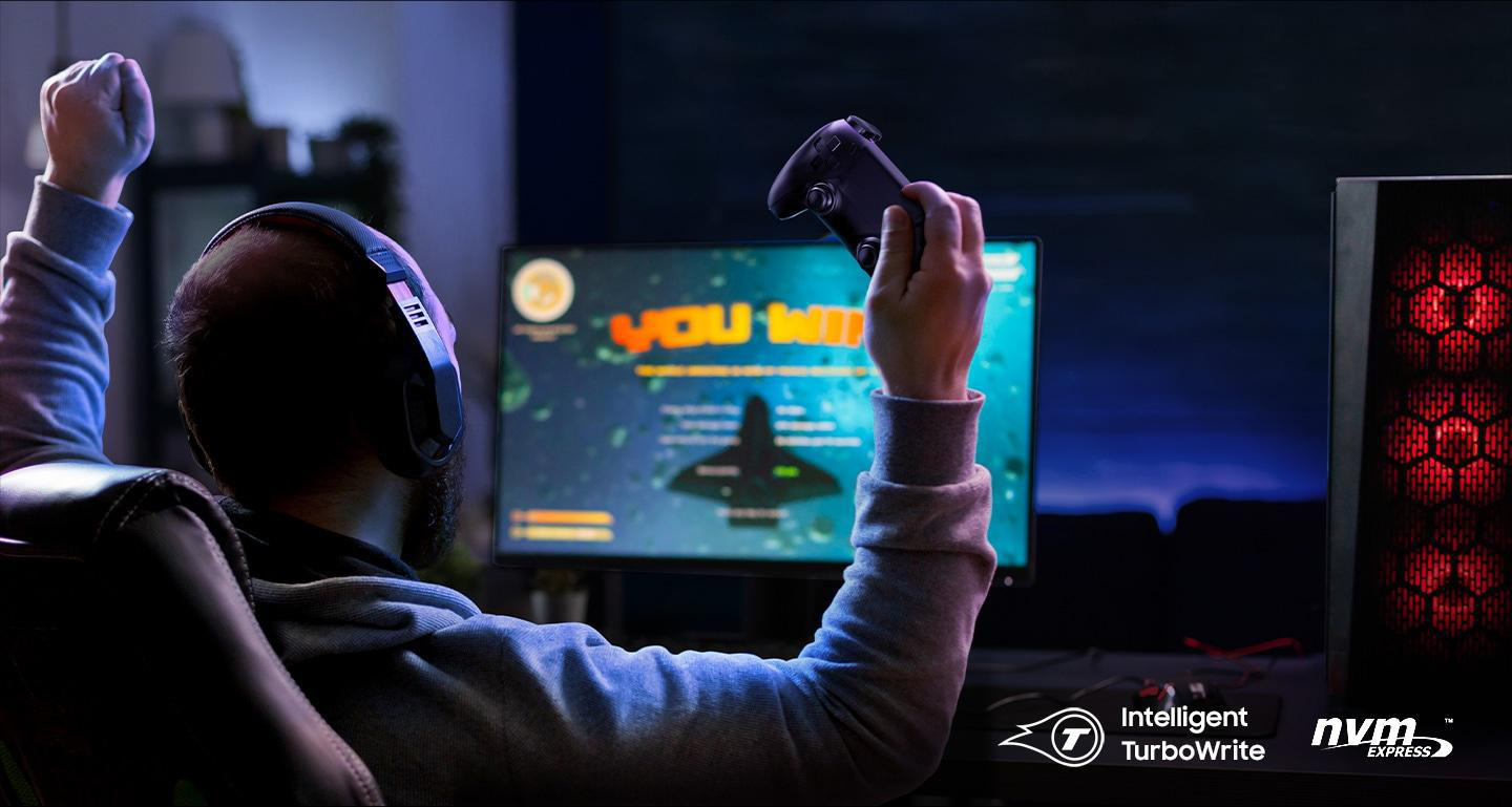 Gamer feiert den Sieg. Er hält Controller, Bildschirm zeigt Spiel mit 'YOU WIN' Nachricht.