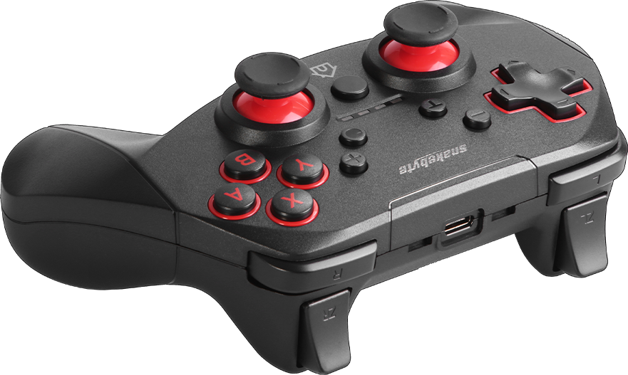 Fekete gamepad piros gombokkal és joystickokkal, ferde nézet fekete háttéren.