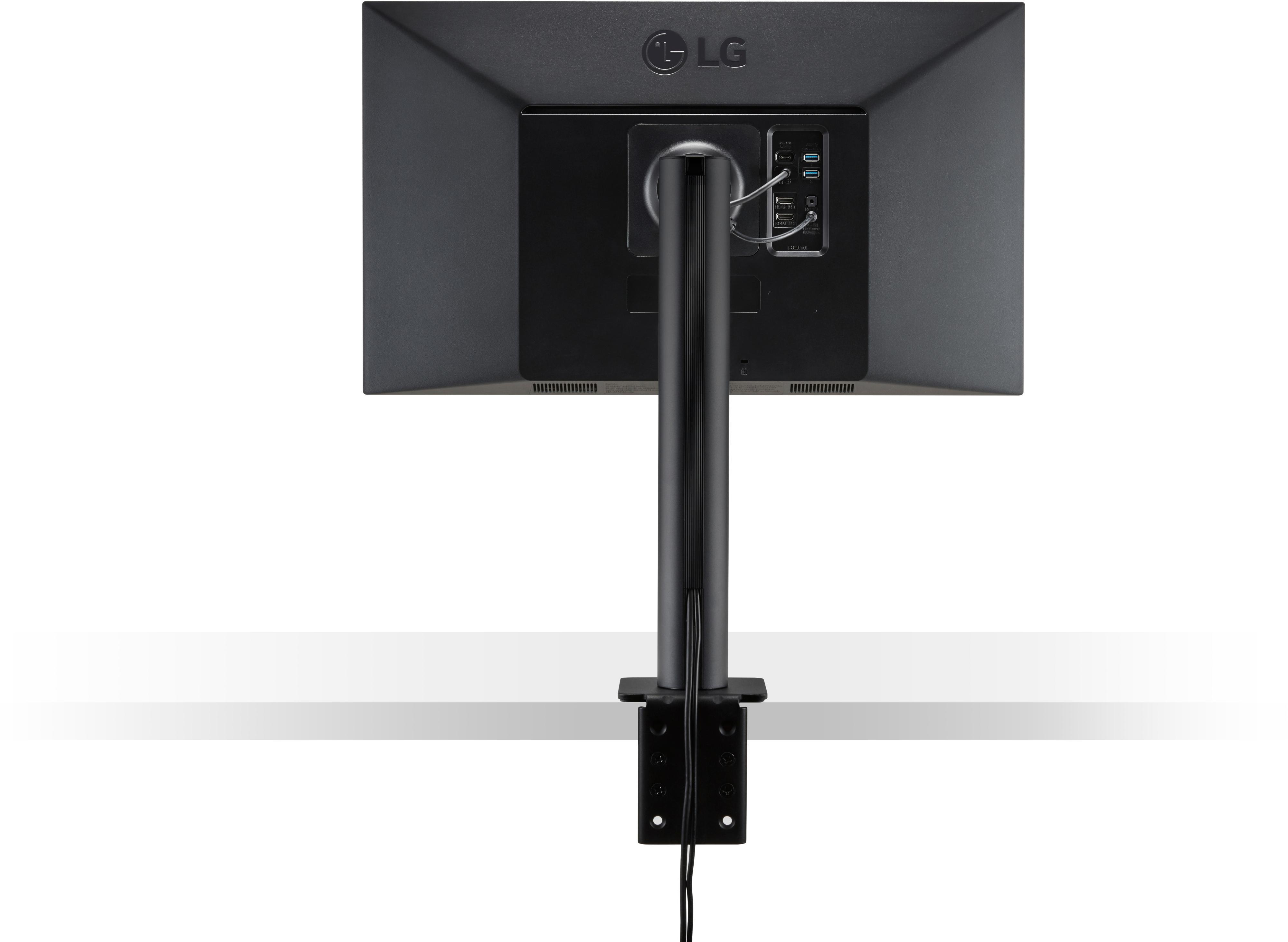 Rückseite eines schwarzen Computermonitors auf einem Ständer montiert. Weiße Oberfläche.