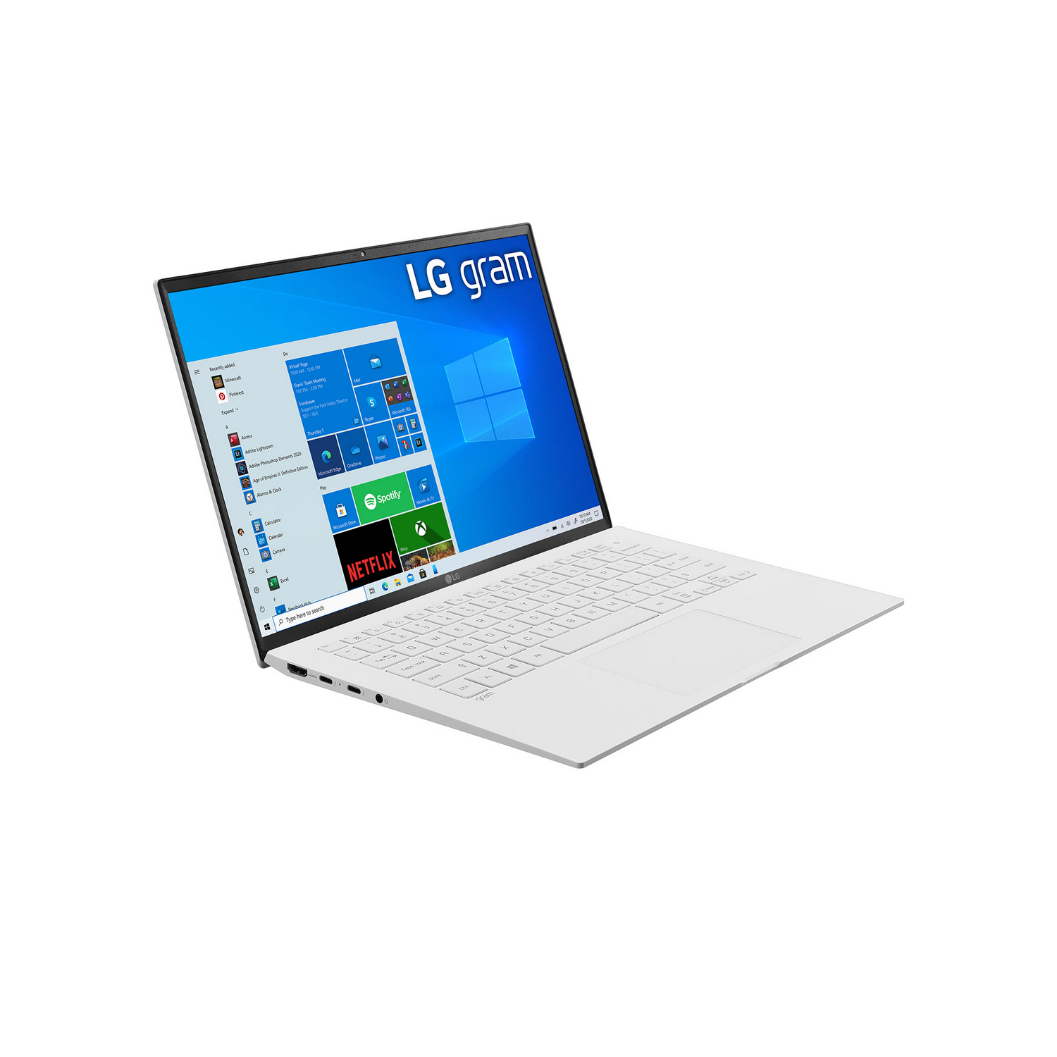 Una computadora portátil LG gram blanca está abierta sobre una superficie blanca.
