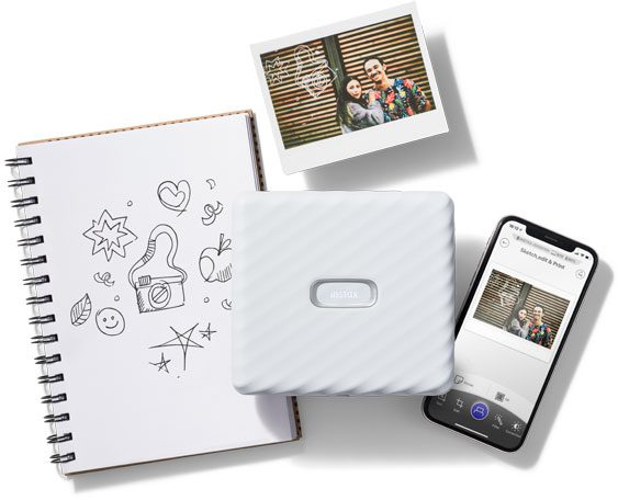 White printer, notebook with drawings, photo and phone, all on white background.