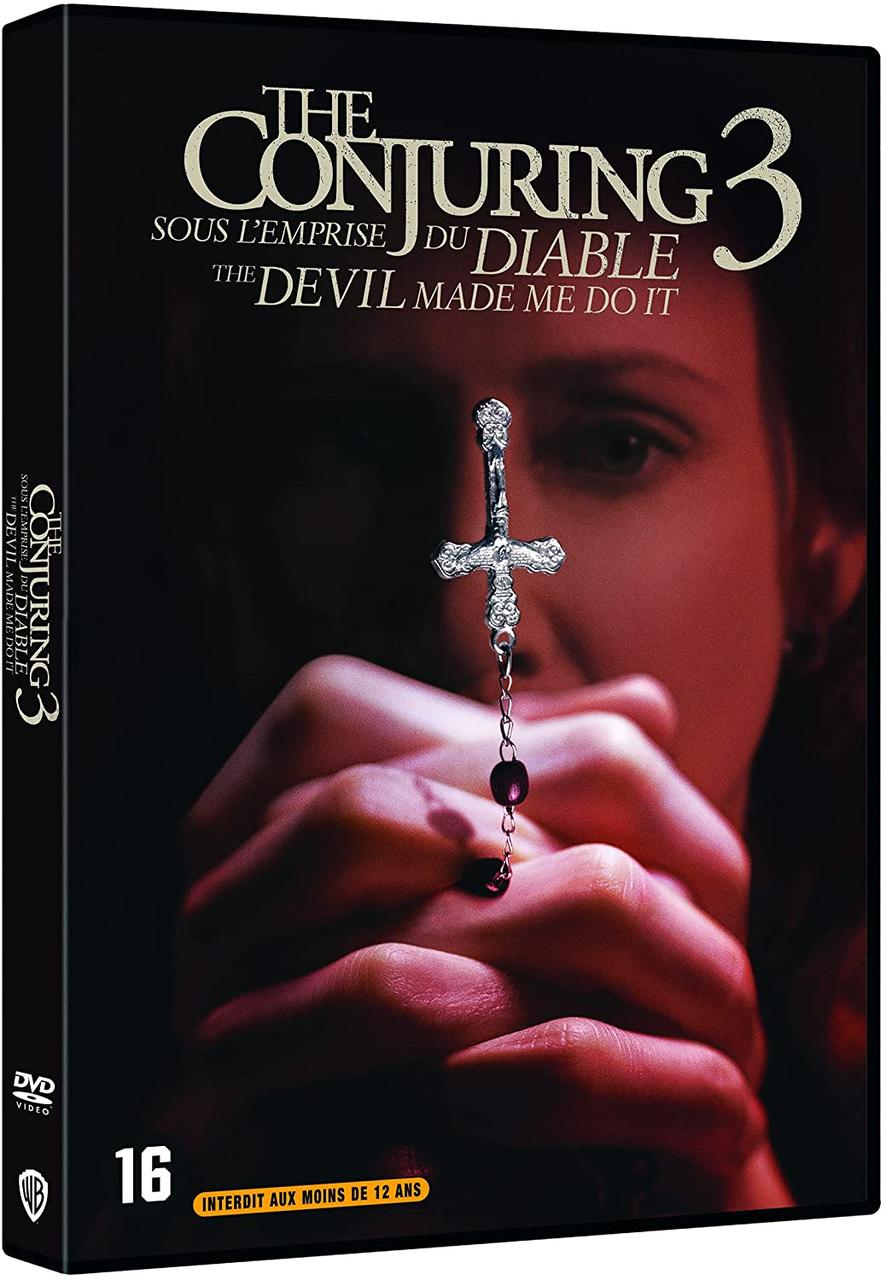 Couverture du film 'The Conjuring 3'. Le visage d'une femme avec une croix et un chapelet.
