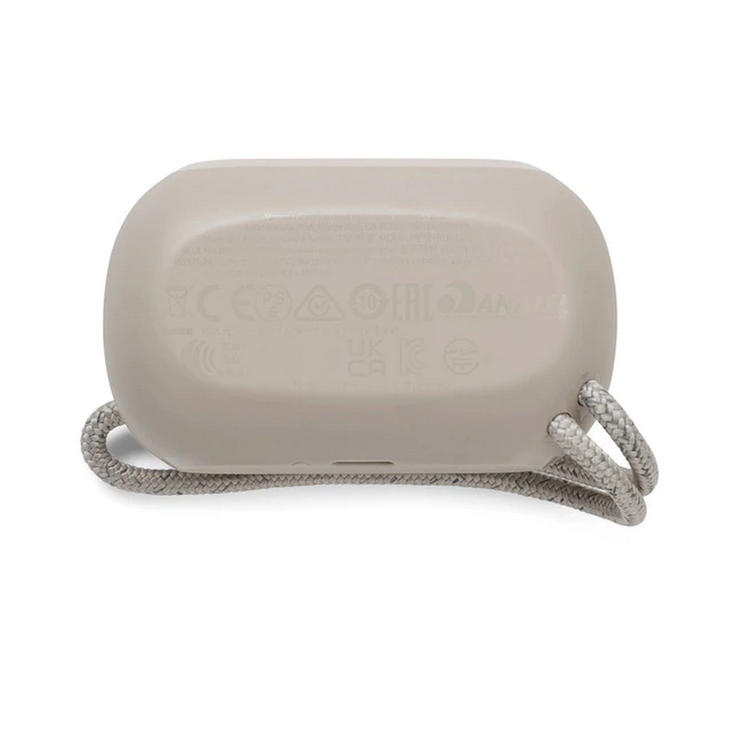 Un altavoz beige, vista inferior, mostrando los detalles de la base y un asa de cuerda.
