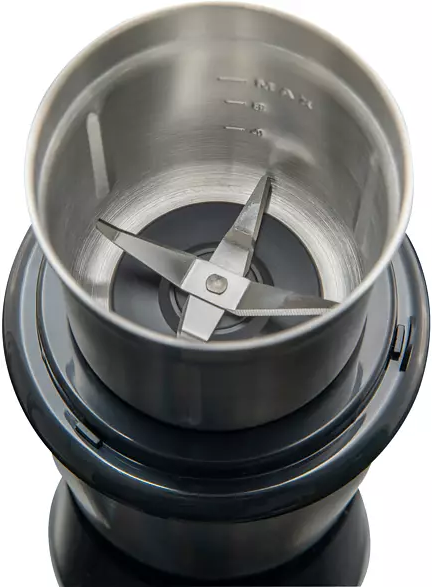 An overhead view of a coffee grinder. It has a stainless steel bowl and blades.