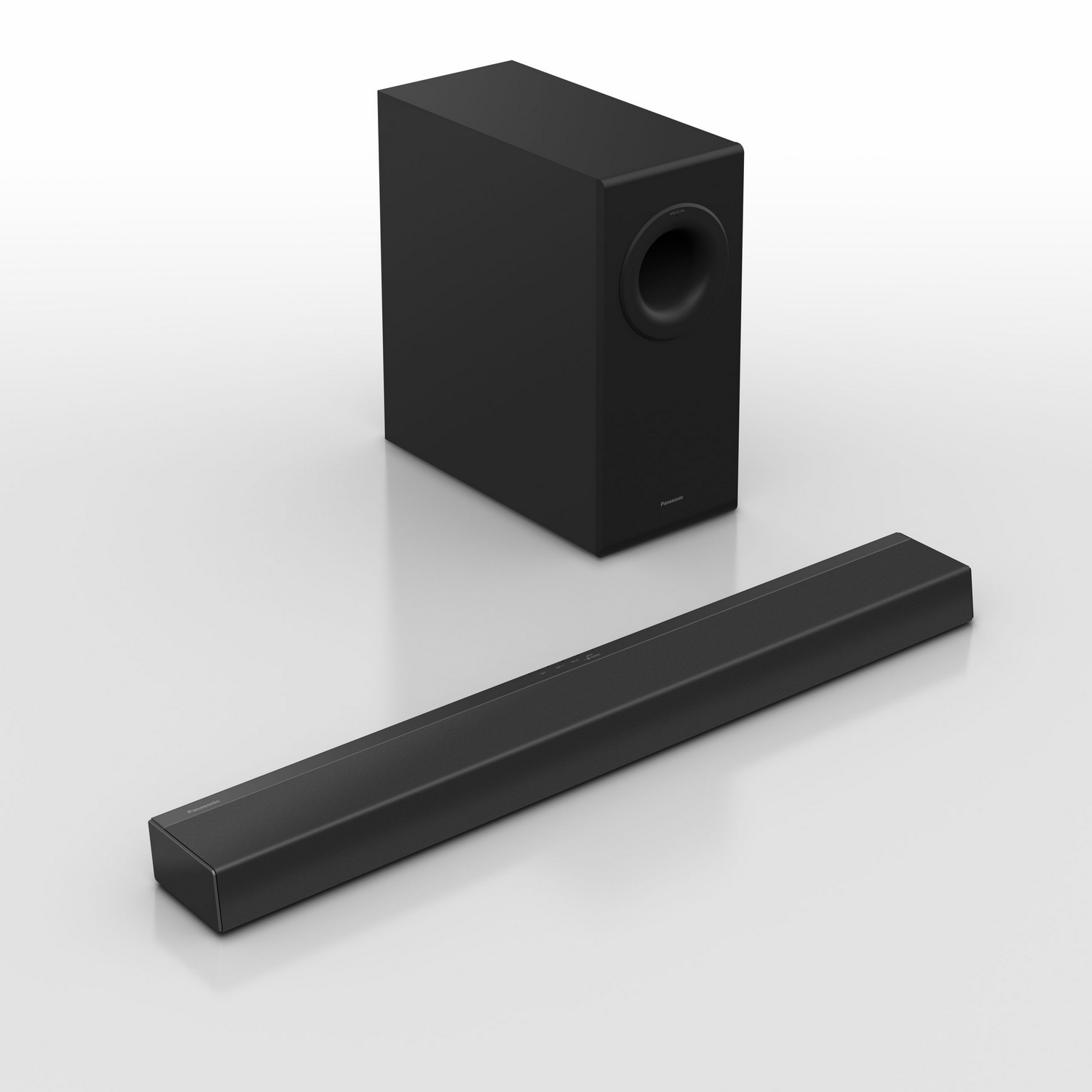 Barra de sonido negra con subwoofer. La barra es rectangular y el subwoofer un cubo.