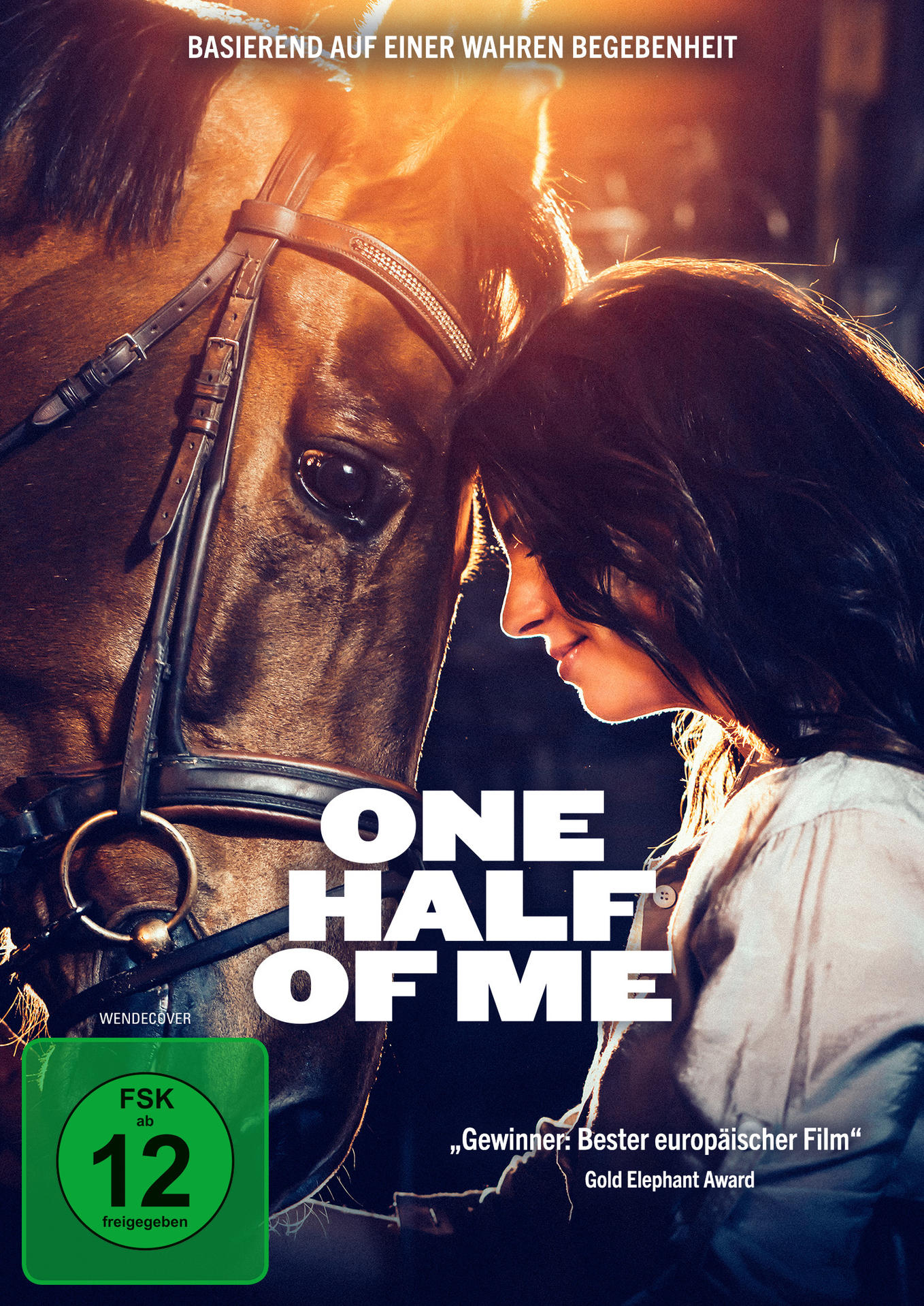 DVD-Cover: Frau berührt Pferdekopf. Titel: 'One Half of Me'. Grünes FSK 12 Logo.