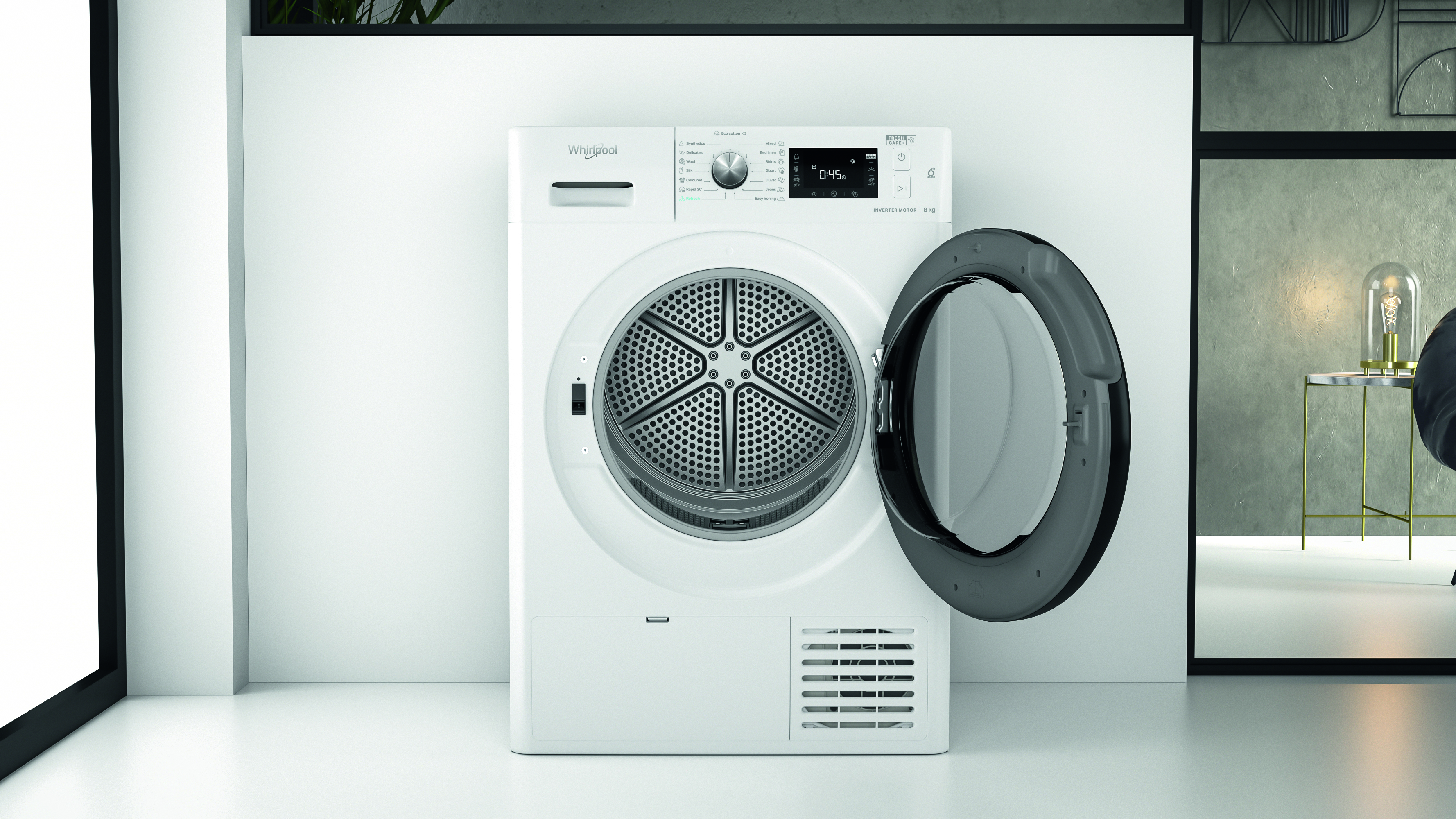 Fehér Whirlpool szárítógép nyitott ajtóval. Fehér szobában, ablakkal.