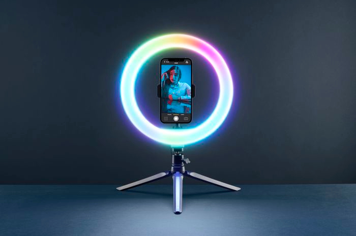 Phone in ring light, tripod. Woman on screen.