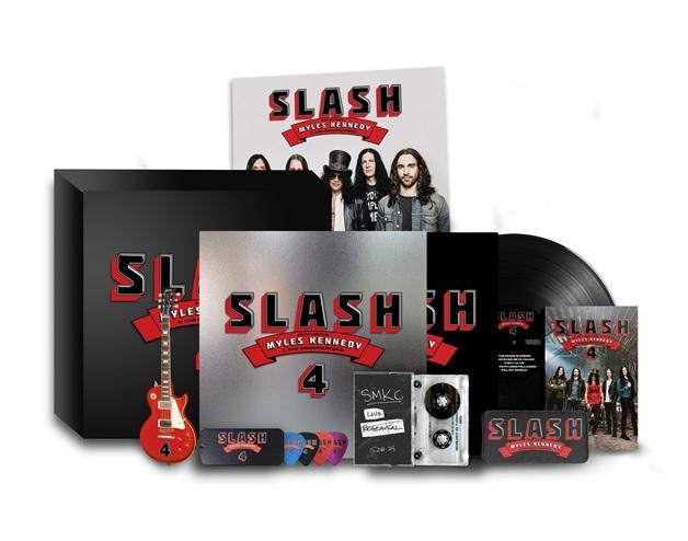 Slash album és kapcsolódó elemek. Pengető, bakelit, kazetta és egy gitár.