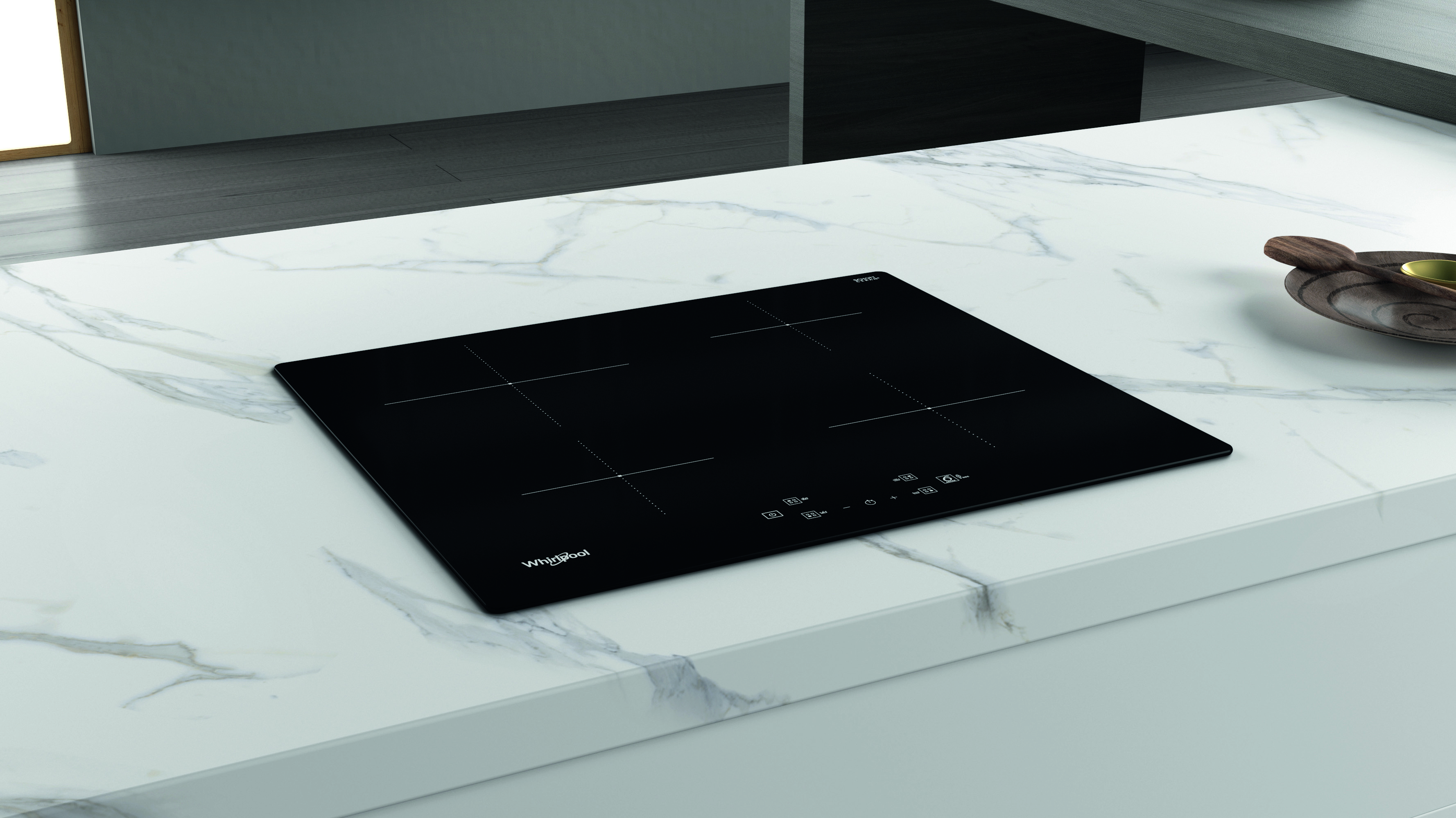 Fekete Whirlpool indukciós főzőlap fehér márvány munkalapon.