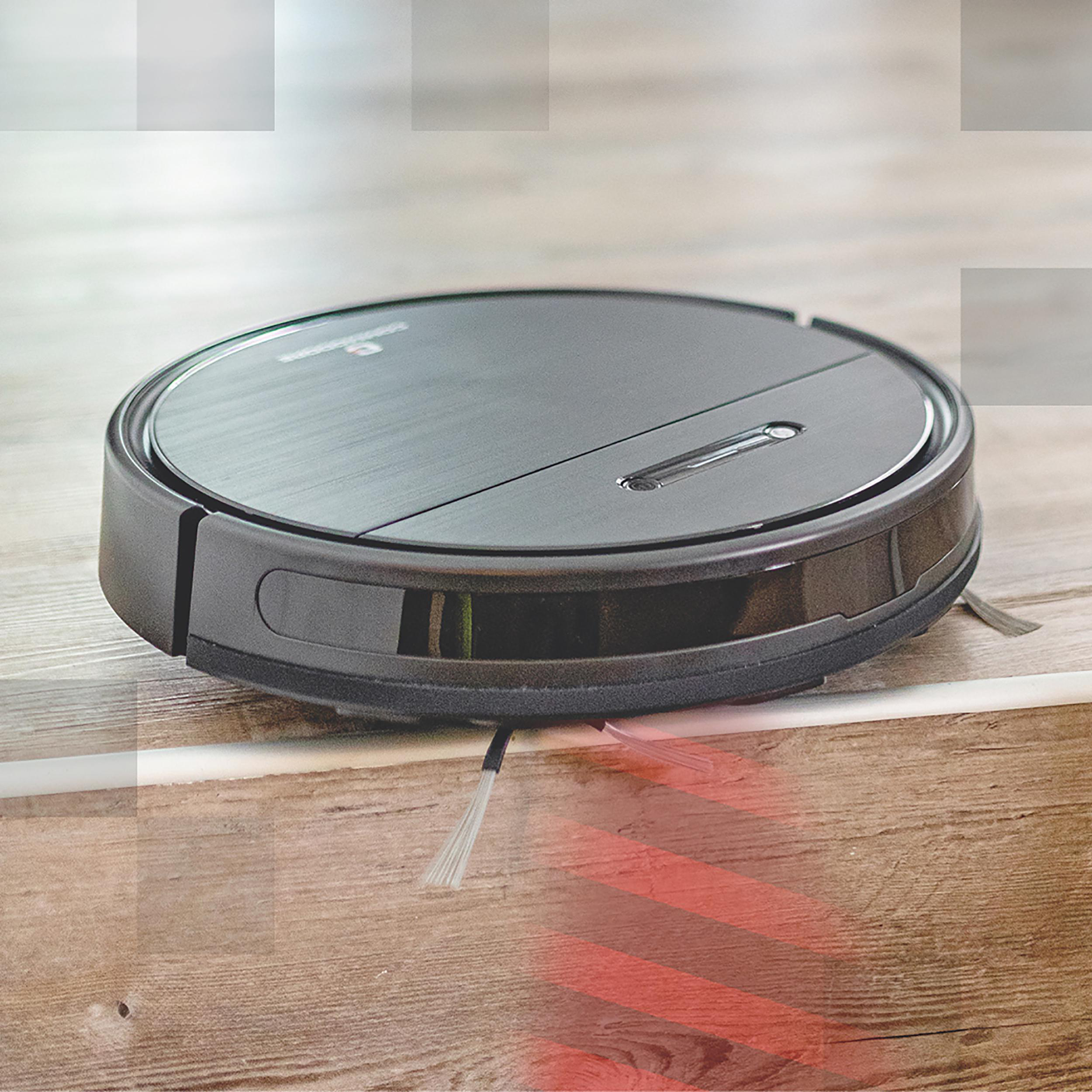 Ein Roboter-Staubsauger auf einem Holzboden, mit rotem Licht.