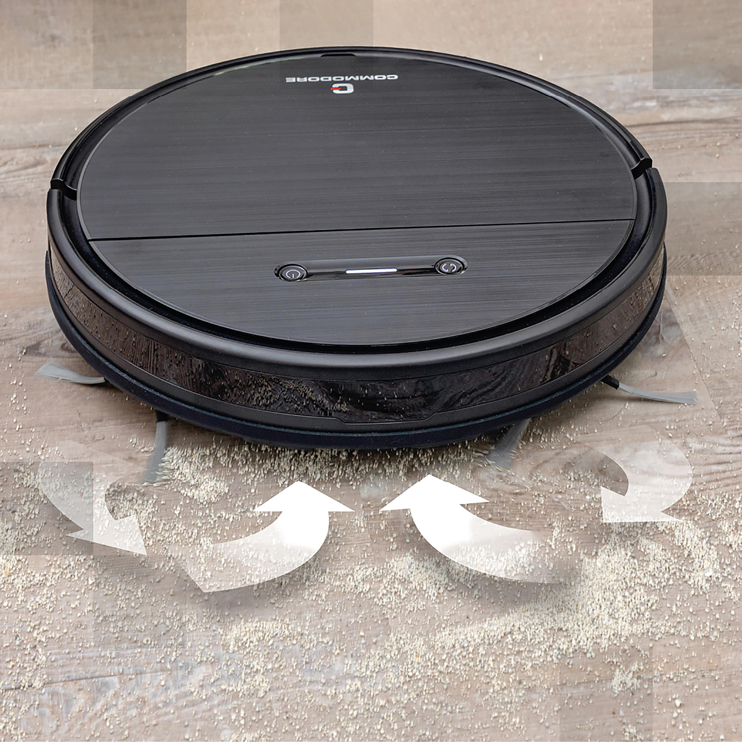 Schwarzer Roboter-Staubsauger auf Holzboden reinigt Staub, mit Pfeilen, die seinen Weg anzeigen.