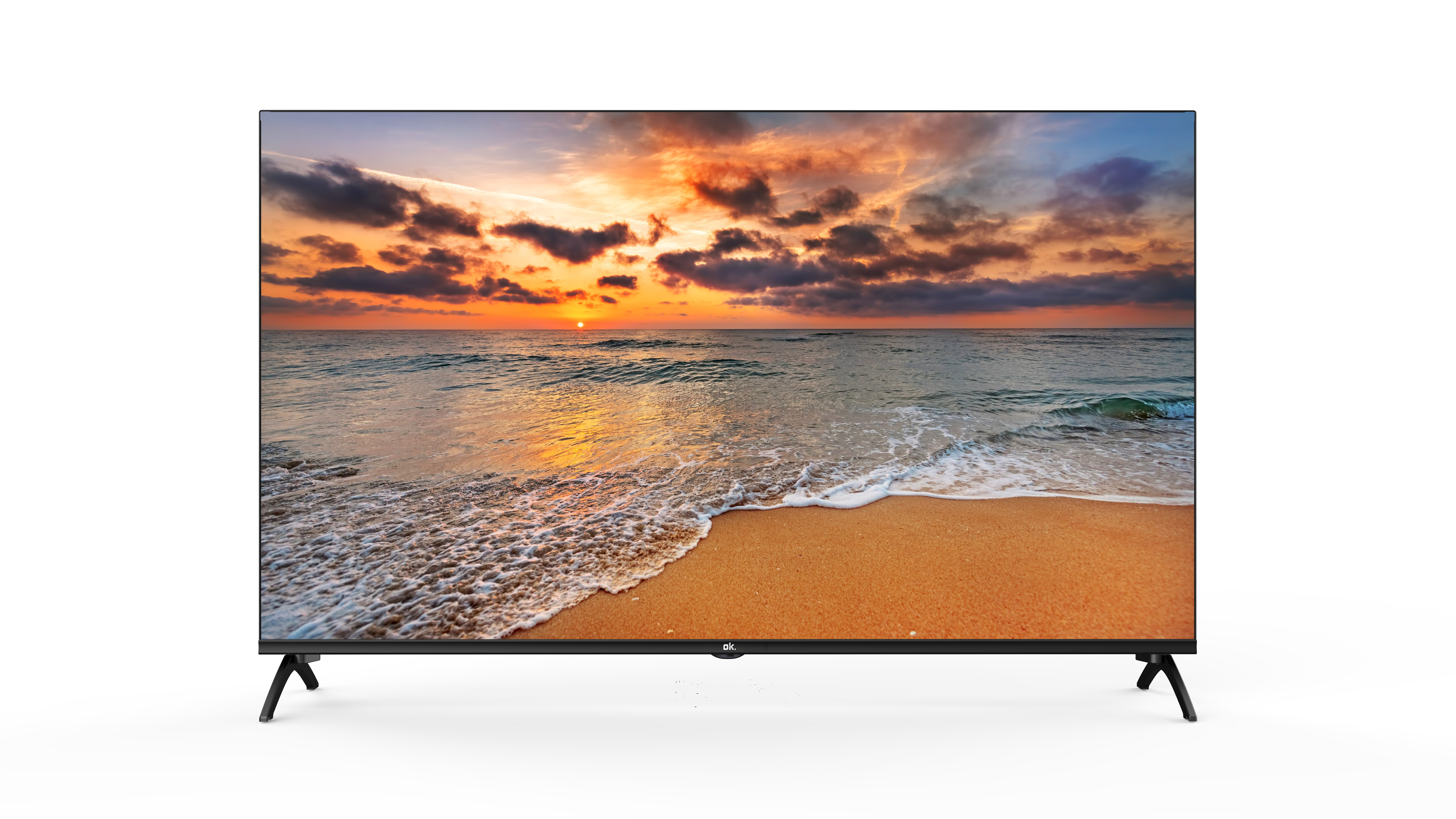 Ein Flachbildfernseher zeigt einen Sonnenuntergang über dem Meer und Strand.