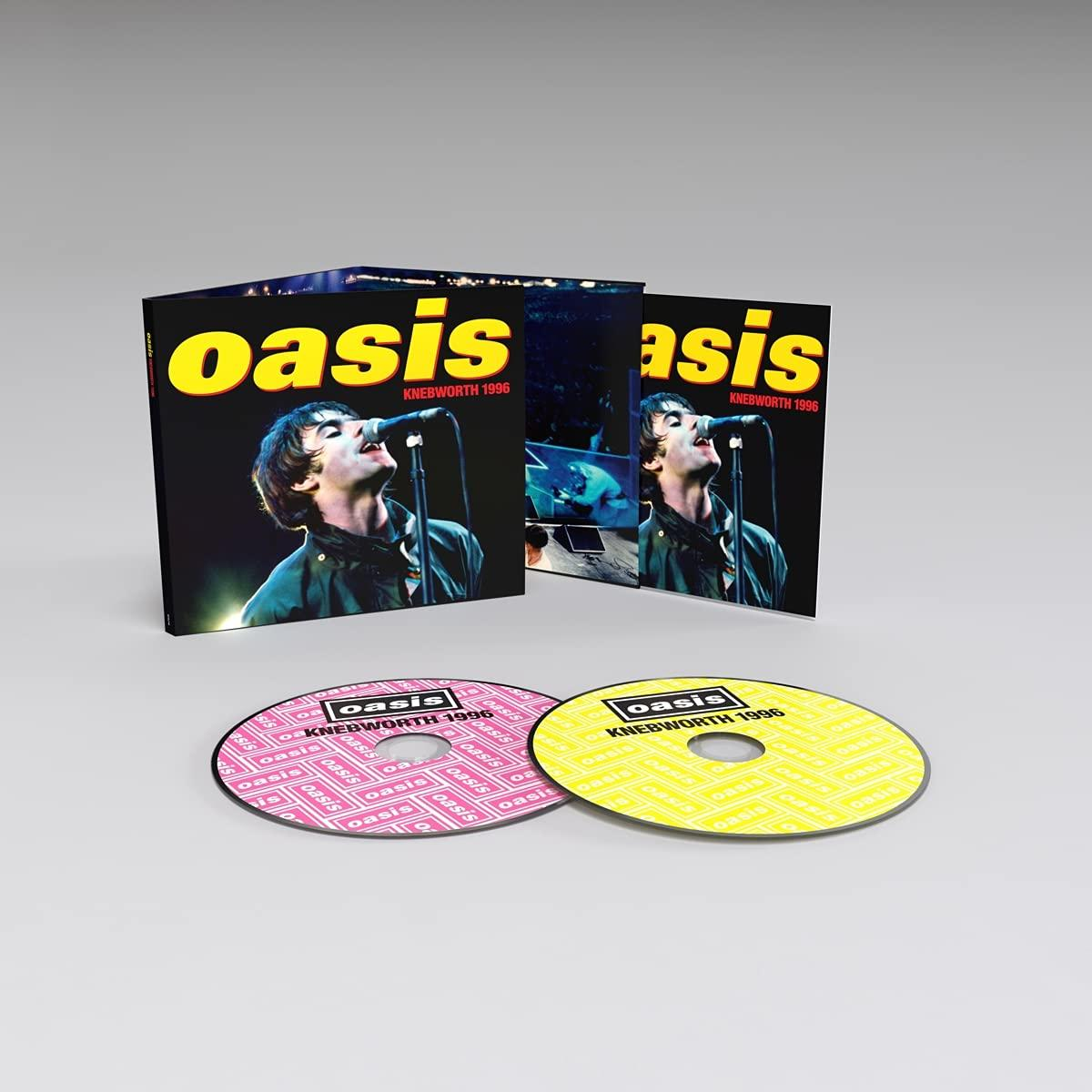 Oasis-Albumcover und zwei CDs. Das Cover zeigt einen Sänger auf der Bühne mit dem Bandnamen.
