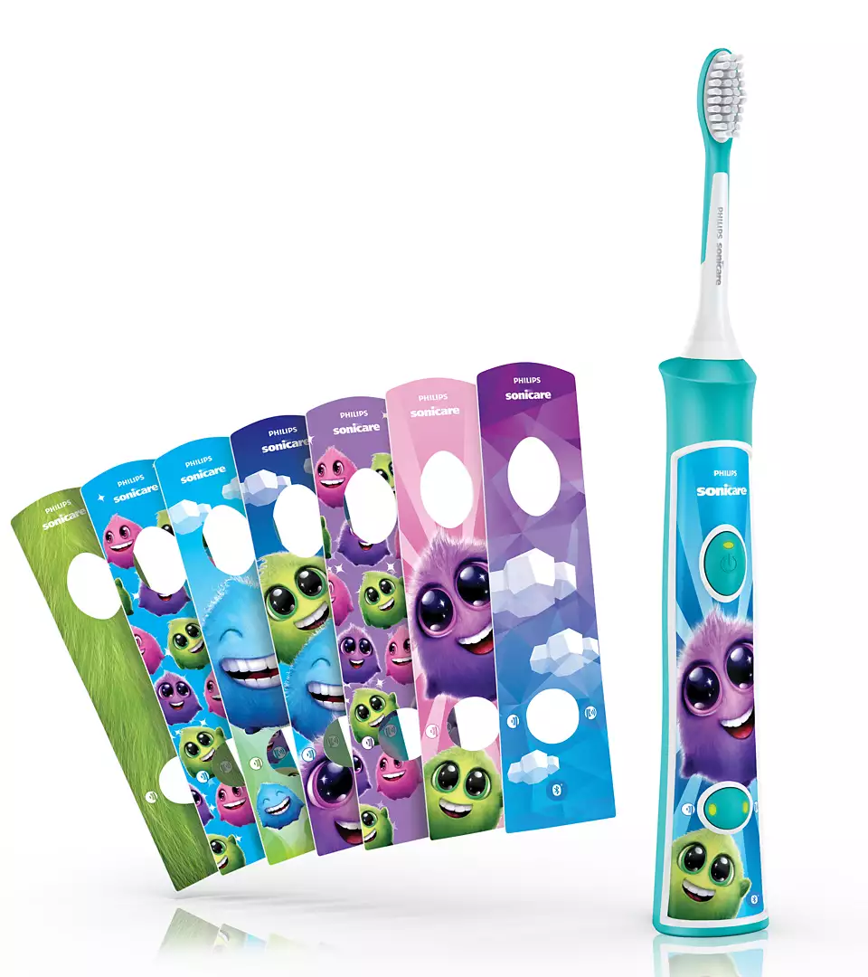 Une brosse à dents électrique Philips Sonicare turquoise avec des têtes de brosse sur le thème des monstres.