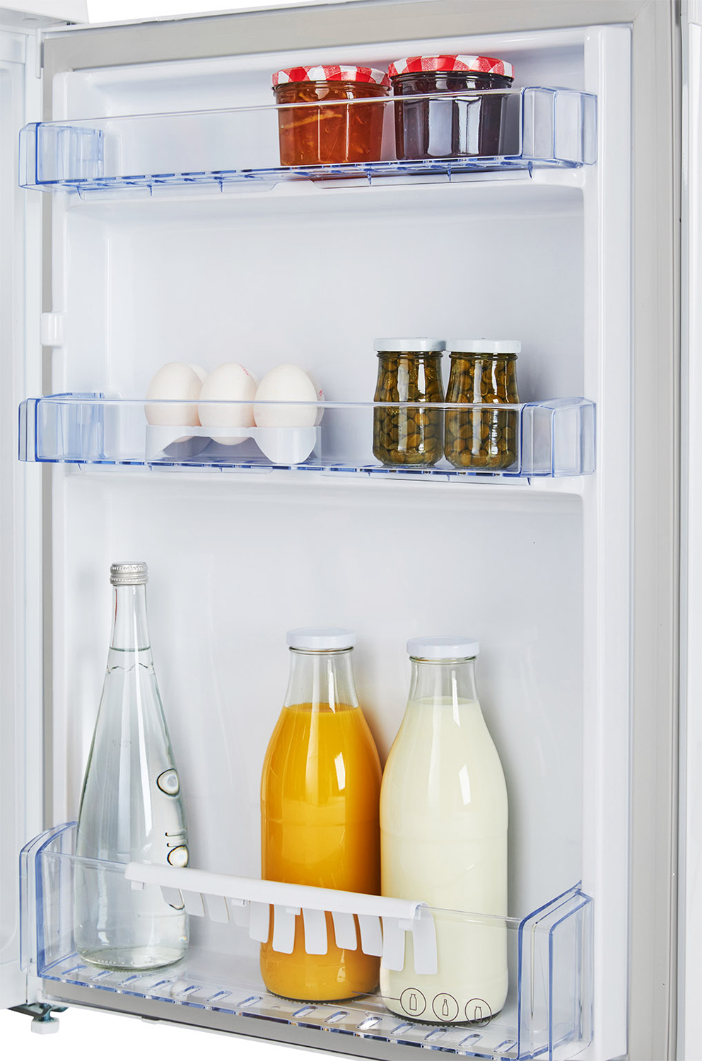 A fridge interior with shelves holding jars, eggs, and bottles.
