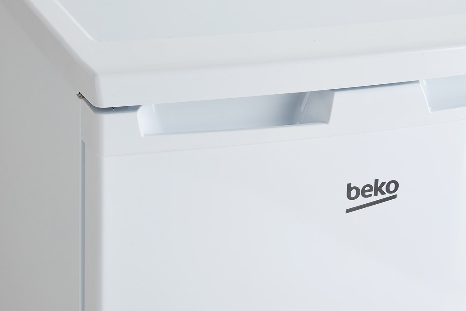 Close-up of a white Beko freezer with the Beko logo on the door.